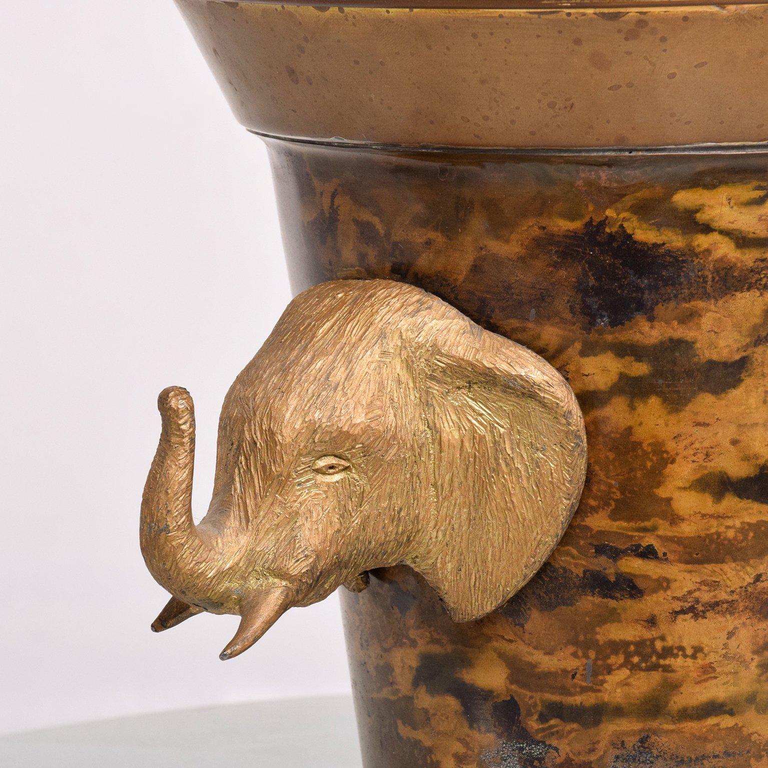 For your consideration a vintage ice bucket made of brass. Beautiful and unique. The bucket is made of brass and has a patinated églomisé finish on the brass. The handles are elephants made of solid brass. Matching lid.

Unmarked, no information