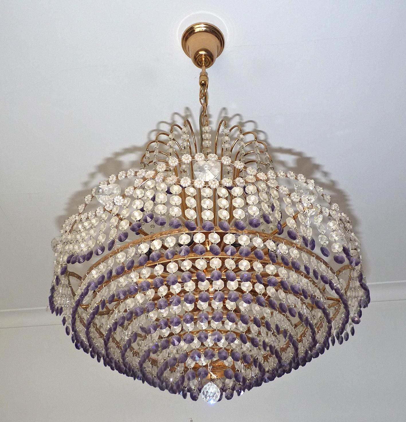 Stunning French Hollywood Regency Empire amethyst cut crystal and gilt brass 10-light chandelier with crystal drops and swags
Measures:
Diameter 21.3 in/ 54 cm
Height 37.8 in / 96 cm
Weight 18 lb/8 Kg
Ten light bulbs E14/ good working