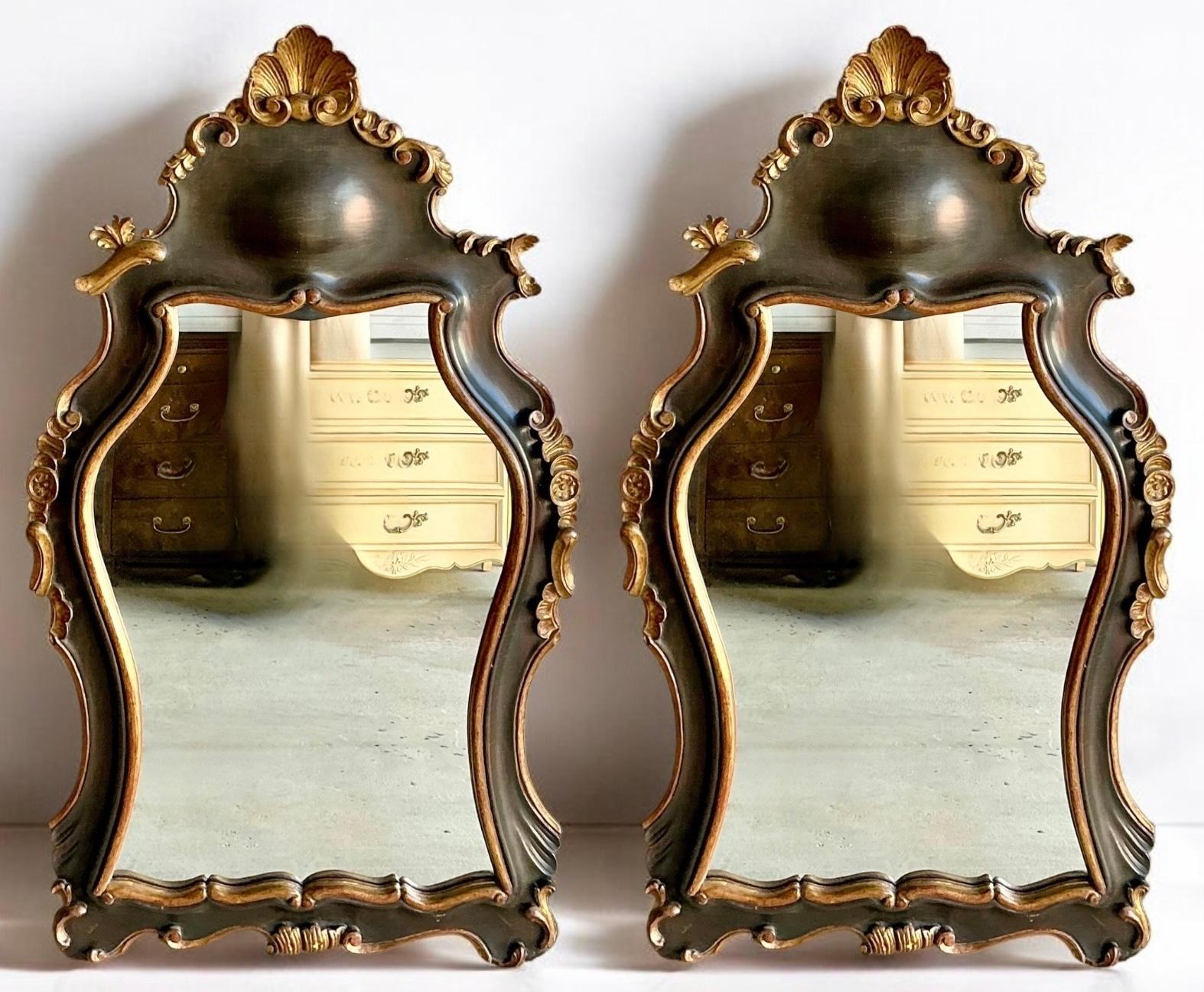 This is a pair of Hollywood Regency Era carved Giltwood mirror with Rococo styling. I love the carved giltwood shell pediment and the free form carved frame. The finish is a deep brown…espresso. They are Italian and date to the 1960s. Both are in