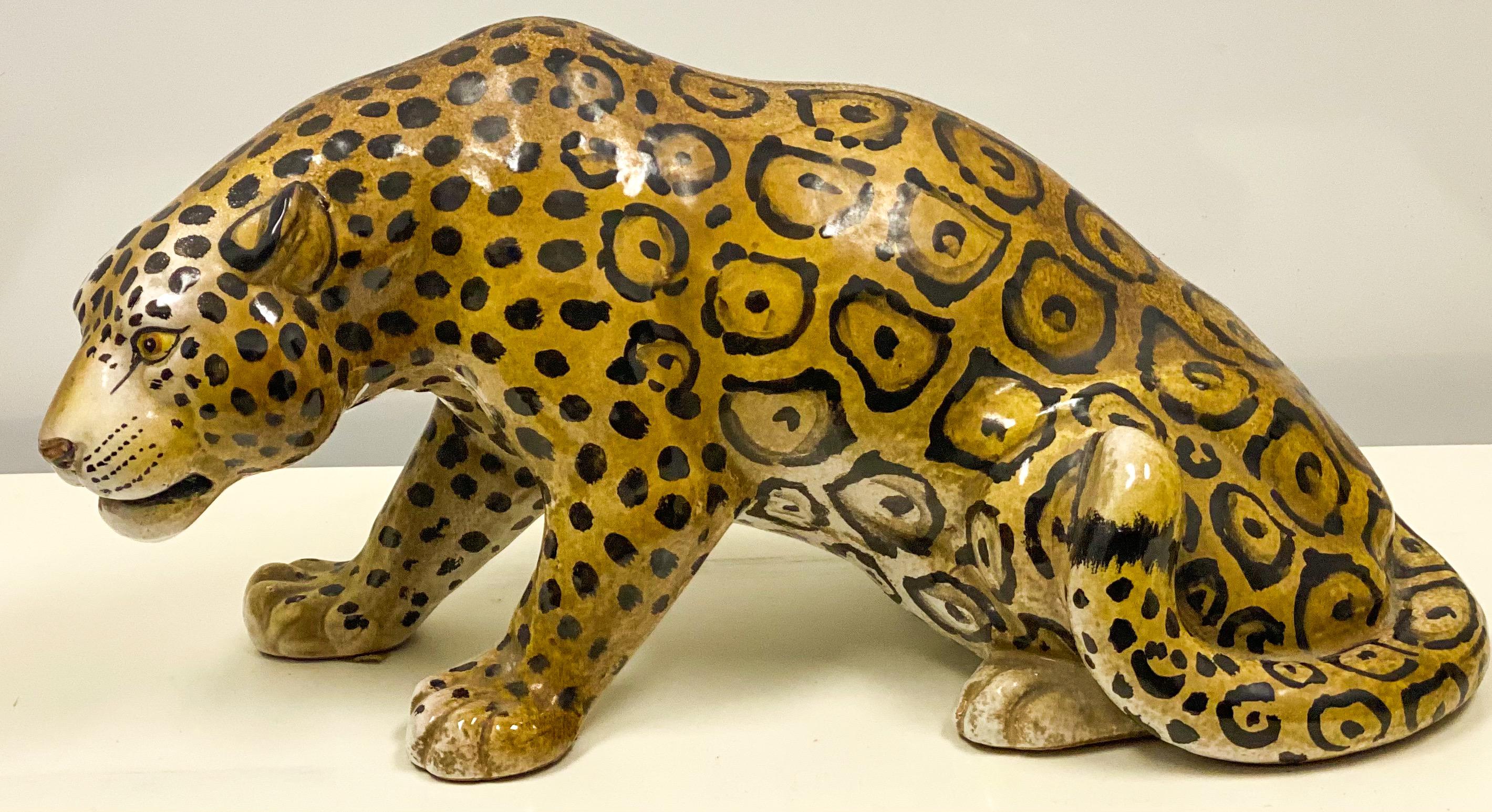 This is a large scale Hollywood Regency Era crouching Italian terracotta leopard figurine. He is in very good condition.