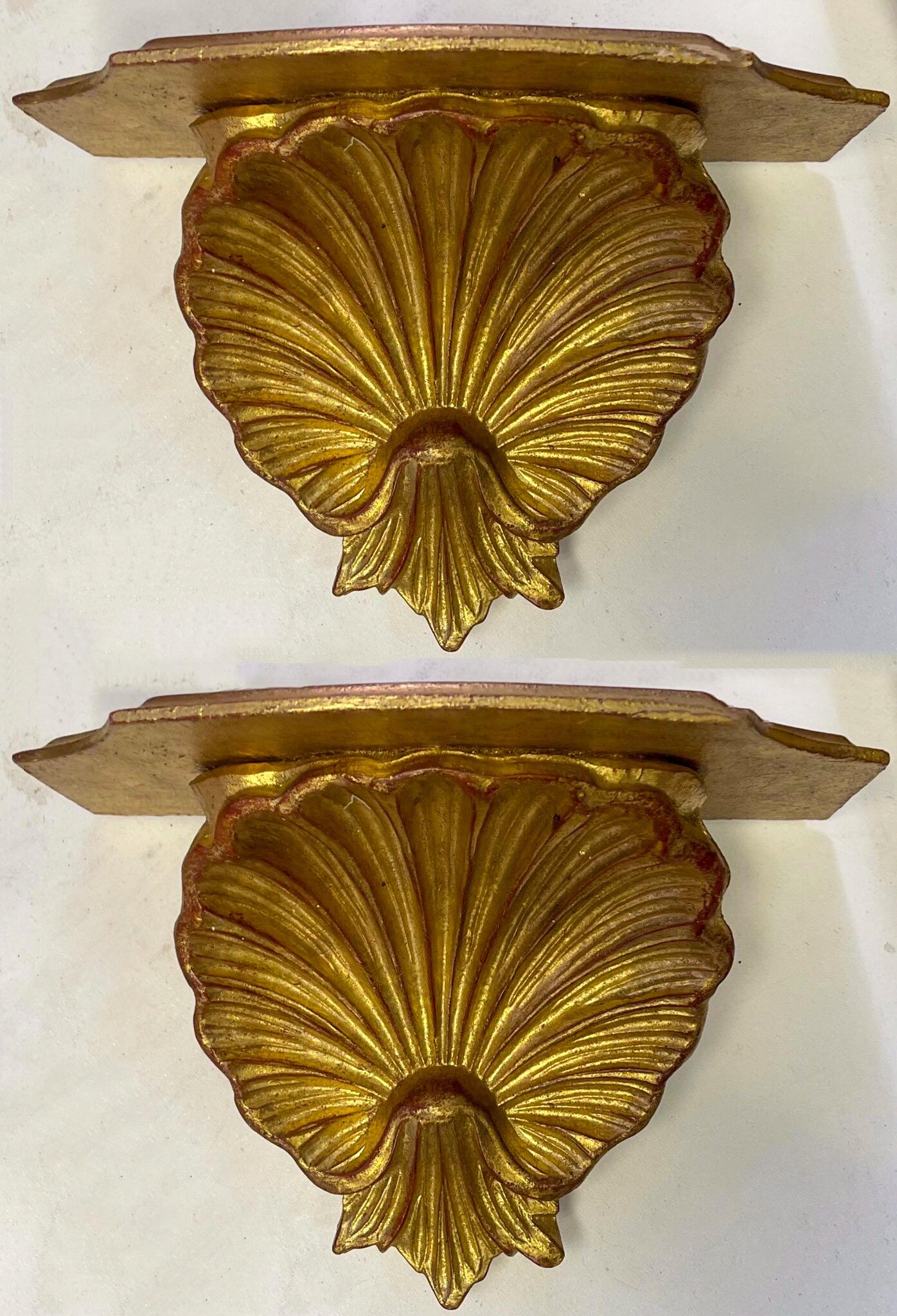 These are a classic! This is a lovely pair of Hollywood Regency Era Italian giltwood carved shell form wall brackets. They are unmarked and in very good condition.