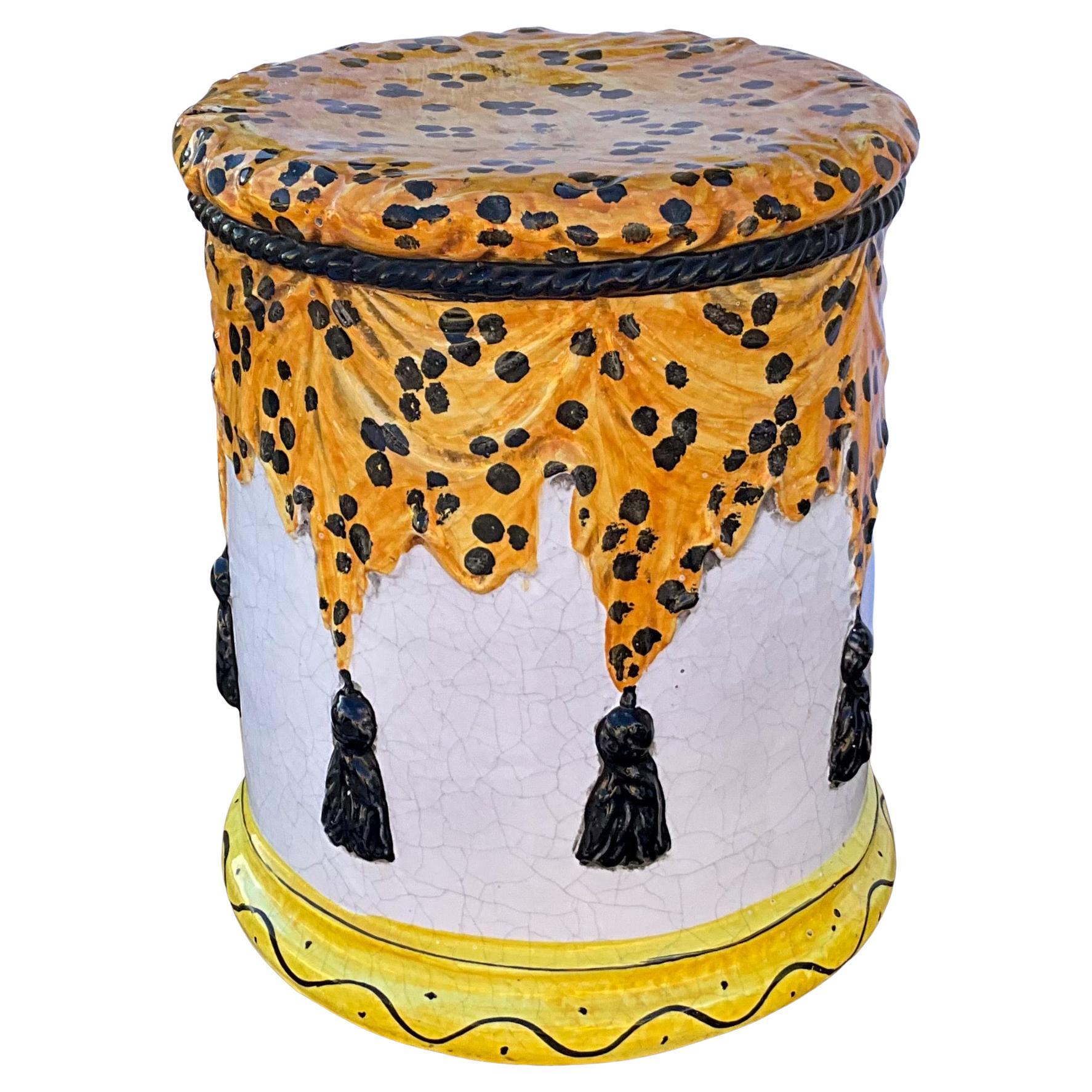 This is a Hollywood Regsncy leopard and tassel majolica garden stool. It is Italian and terracotta. It has lite crazing to the glaze.