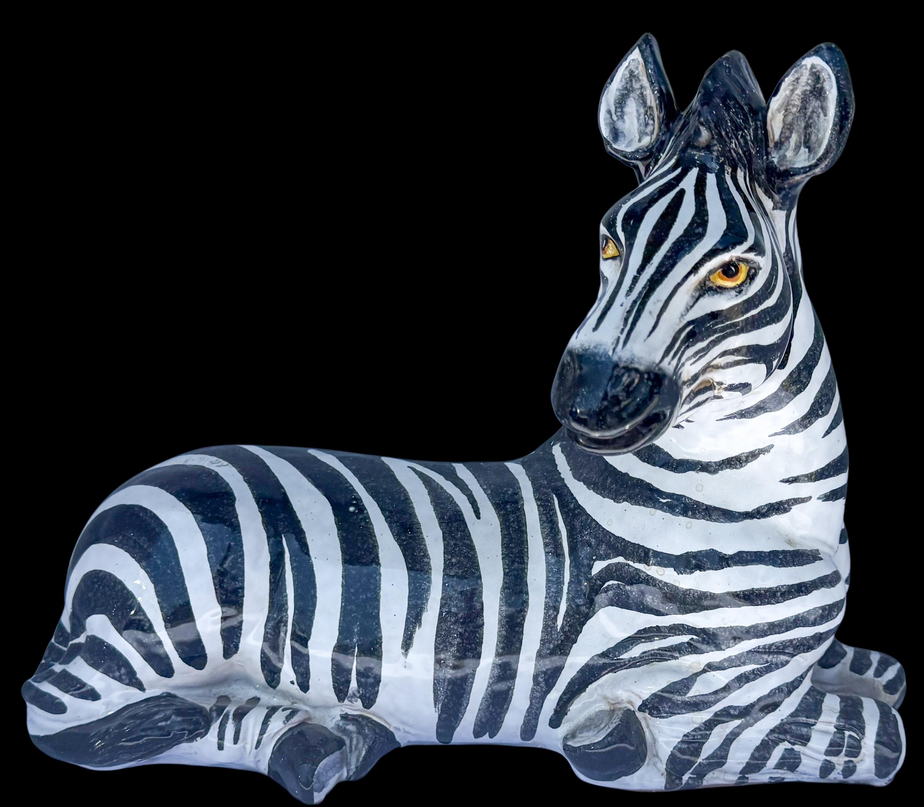 This is a Hollywood Regency Era Italian terracotta recumbent zebra. He is in very good condition. The underside is lined with felt.