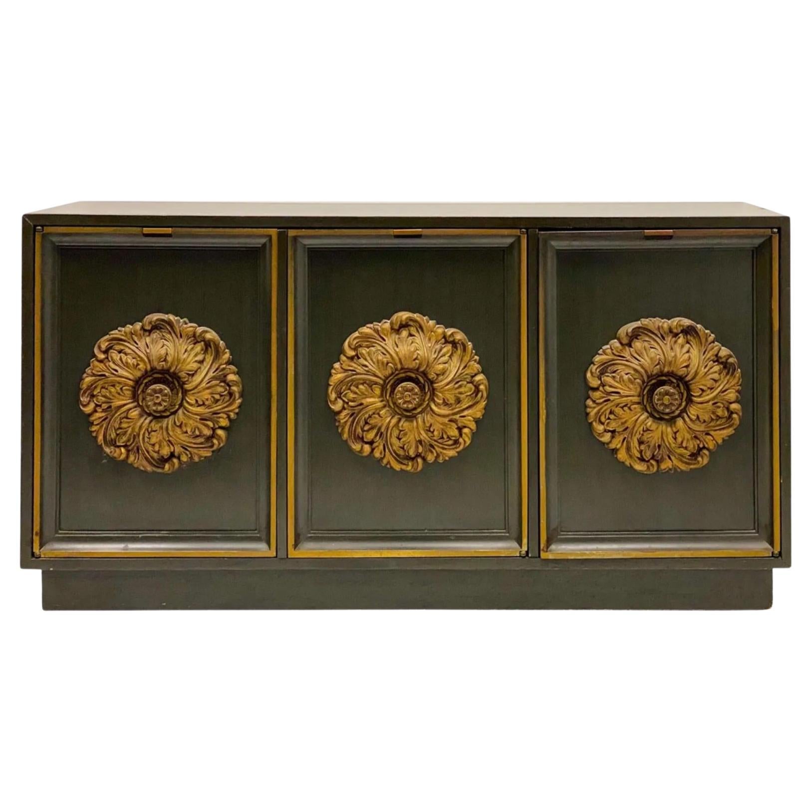 This is a rare find! It is a 1960s Hollywood Regency credenza in the manner of James Mont. it has a distressed green finish that is original. I love the over-sized gilt medallions. The interior is a single shelf. It is marked.

The $400 shipping is