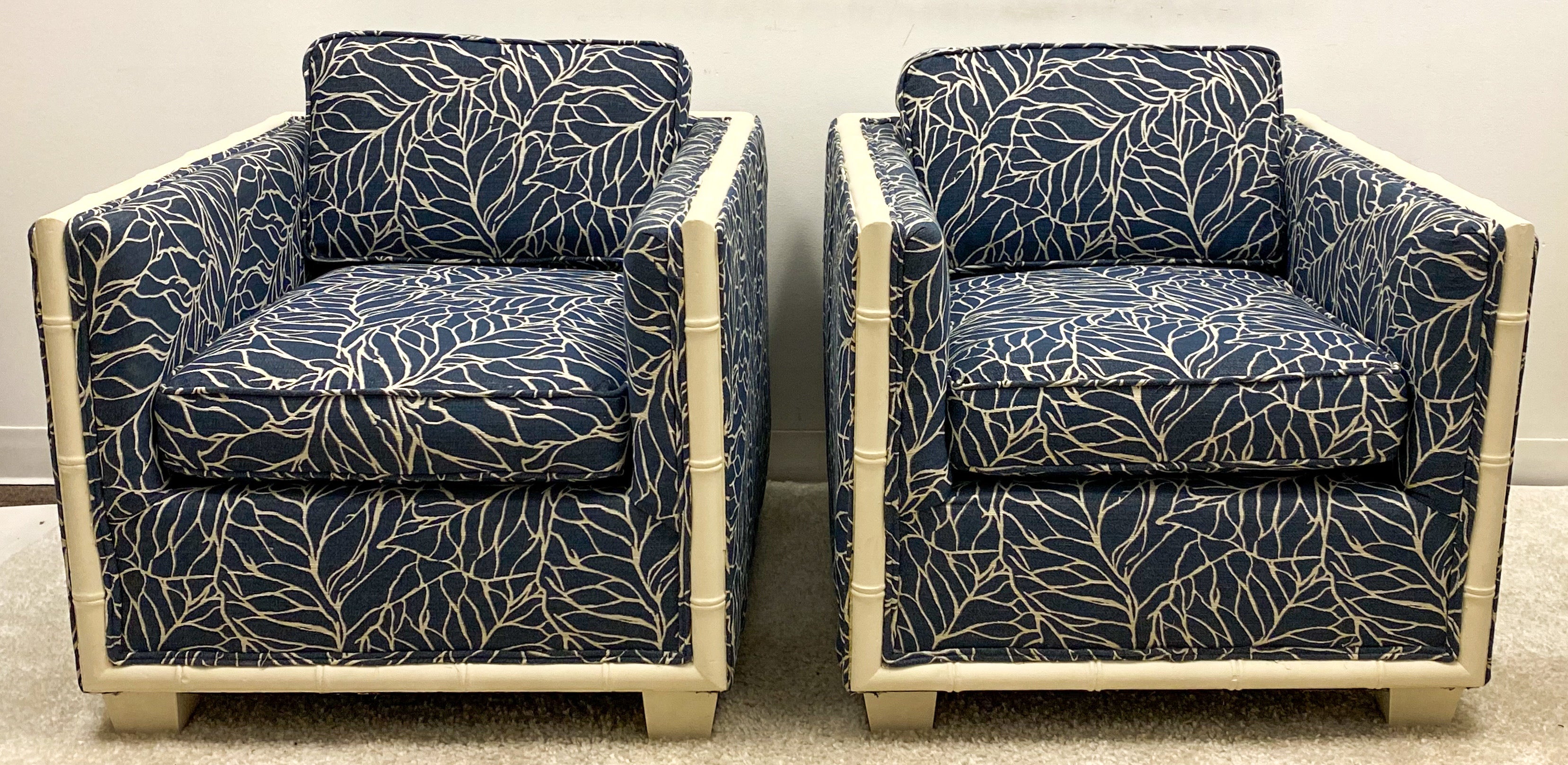 This is a pair of 1960s faux bamboo club chairs that have been updated with new upholstery and painted finish. They are not marked. Back height is 26”.