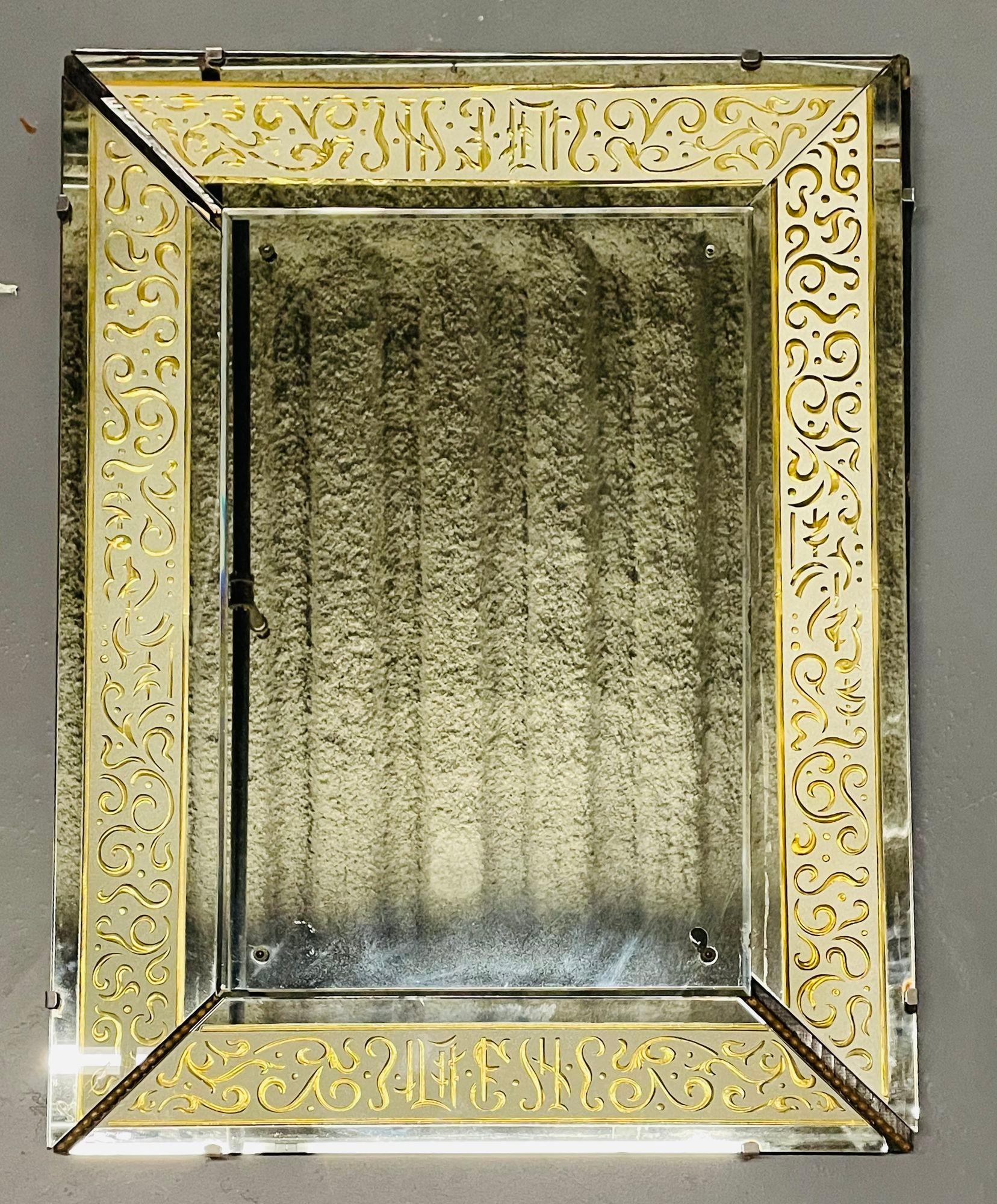 A Hollywood Regency etched and frosted gilt glass framed bevelled wall or console mirror. The centre bevelled mirror flanked by four angular cut etched glass panels each separated by a bronze run of spheres.