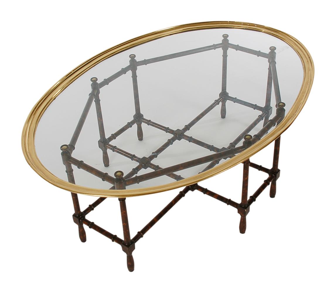 An elegant and stylish tray cocktail produced in the 1960s. It features a tortoise print faux bamboo base with brass framed glass tabletop.