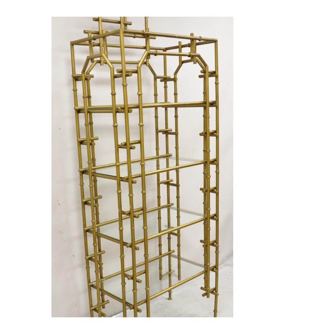 Vintage Hollywood Regency Faux Bamboo Chinese Chippendale Pagoda Gold Painted Metal Etagere with 4 Glass Shelves. Circa Mid 20th Century. Measurements: Overall: 85