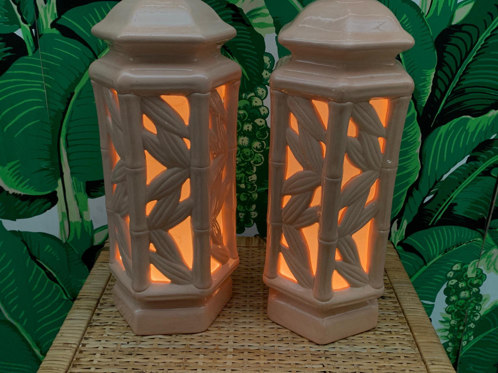 Pair of vintage ceramic table lamps feature faux bamboo detailing and lights within the body. Can be lit with either the main bulb, the body, or both. Very good condition with no cracks or chips.
  
  