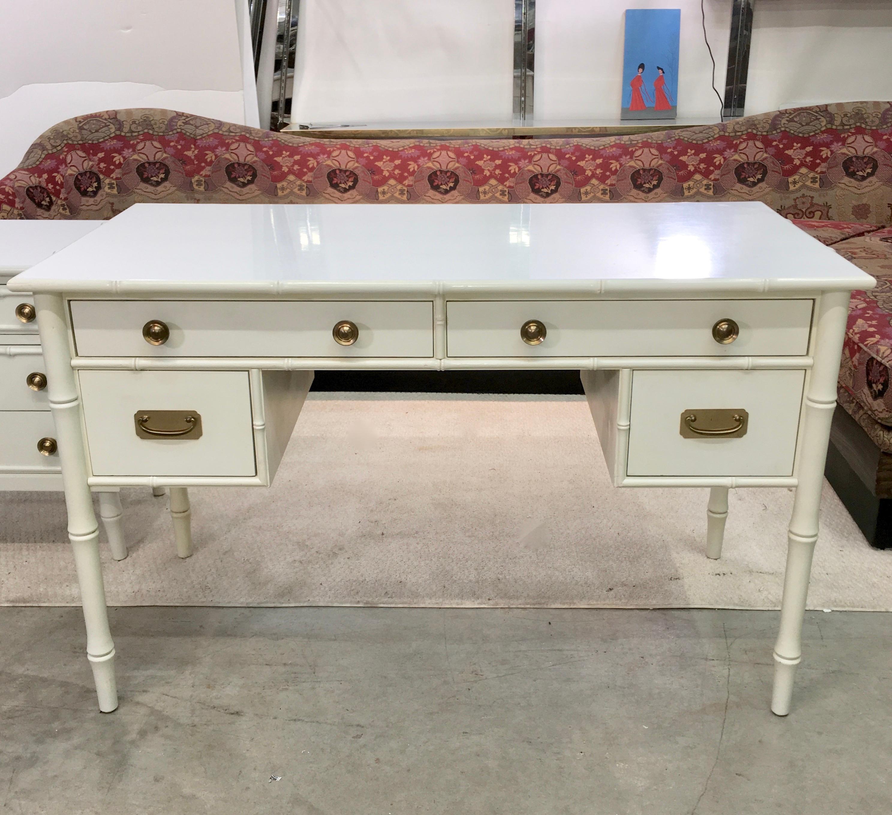 Upmarket vintage 1960s Hollywood Regency faux bamboo painted wood desk attributed to Ficks Reed. White laminate top and posh solid brass hardware. Four drawers. Kneehole 24.5
