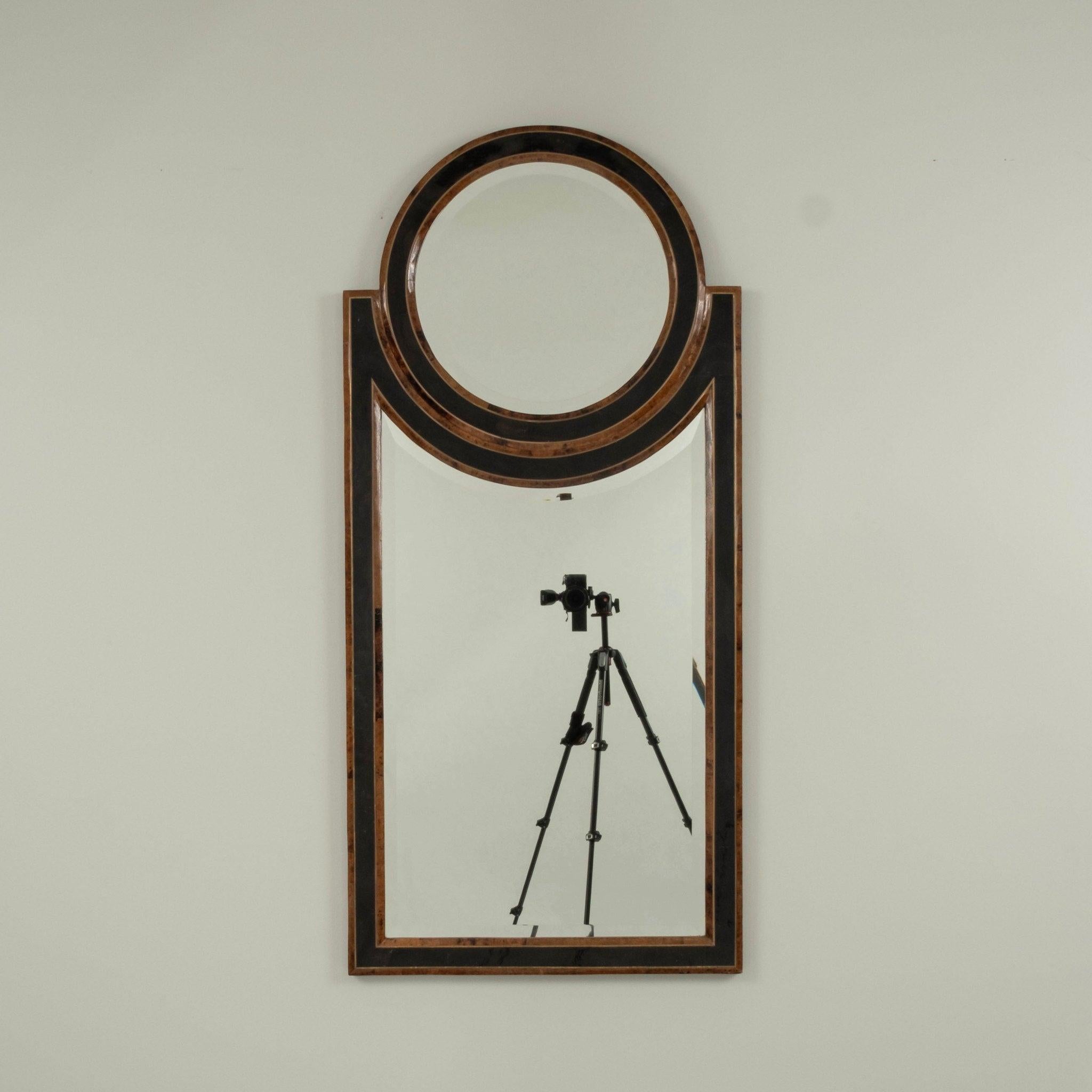20th Century Hollywood Regency beveled mirror featuring a wood frame veneered with faux tortoise penshell and lacquered.