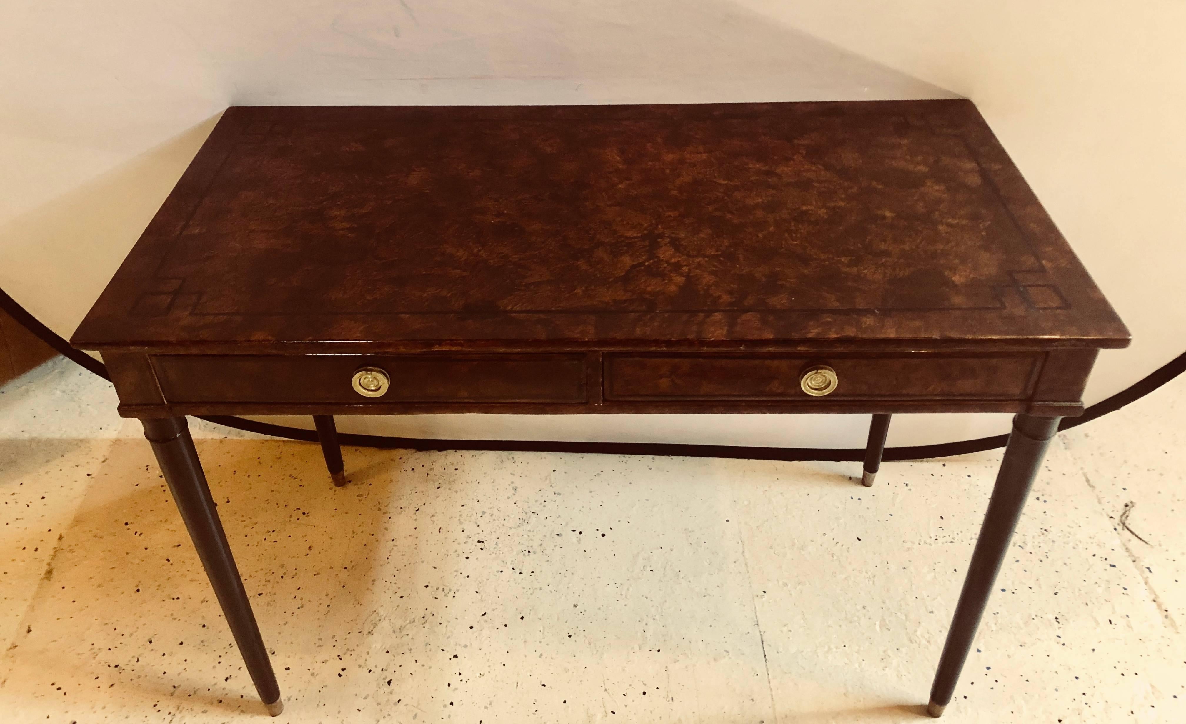 Hollywood Regency faux tortoise two-drawer desk or vanity having Greek key ebony design. This sheik and stylish designed desk or writing table is simply stunning and depicts the Hollywood Regency era of glamour at its highest peak. The top and apron