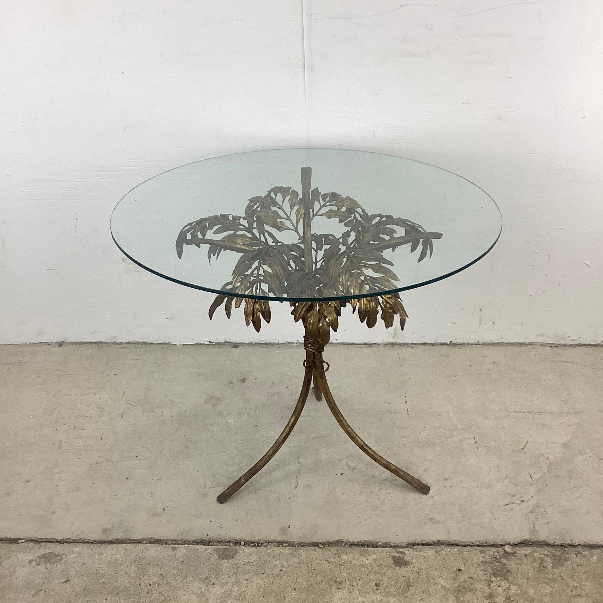 This unique Hollywood Regency Arthur Court style end table features a floral sheath brass finish pedestal base with a circular glass top. Perfect accent table for use as a lamp table, sofa side table, or display pedestal in any setting.

Dimensions: