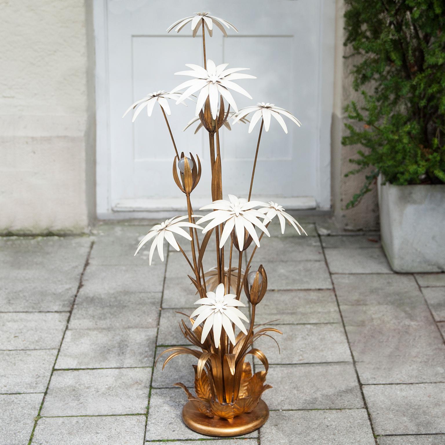 Exotic Hollywood Regency style gilt floral floor lamp. Designed in Germany by Hans Kögl in the 1970s. This classy and rare floor lamp has five lights mounted in beautiful gilded floral metal leaves. Decorated with nine enamel white flowers. With a
