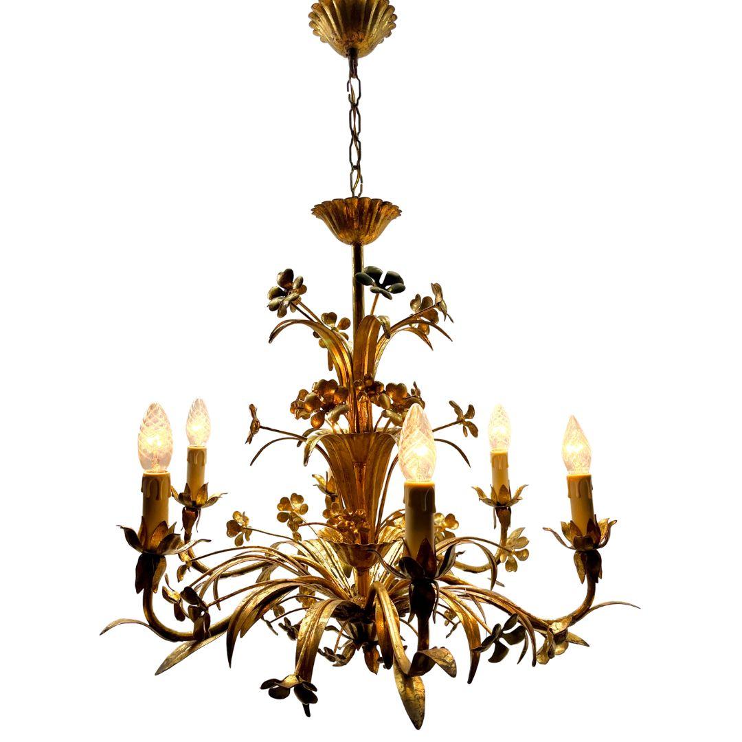Hollywood Regency forget metal floral decor chandelier 1900s.

We are happy to adjust the total height to your wishes at no extra cost.

Photography fails to capture the simple elegant illumination provided by this lamp.
With original Patina on all