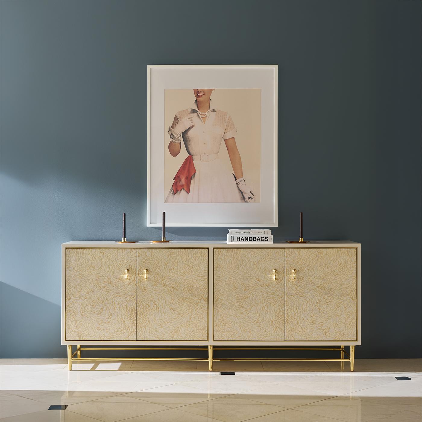 Four Door Cabinet is a shining example of luxury and artistry. Meticulously artisan made, this compact statement piece features hand-painted doors with a swirling, feather-like pattern that adds organic elegance and depth.

Polished brass trim and