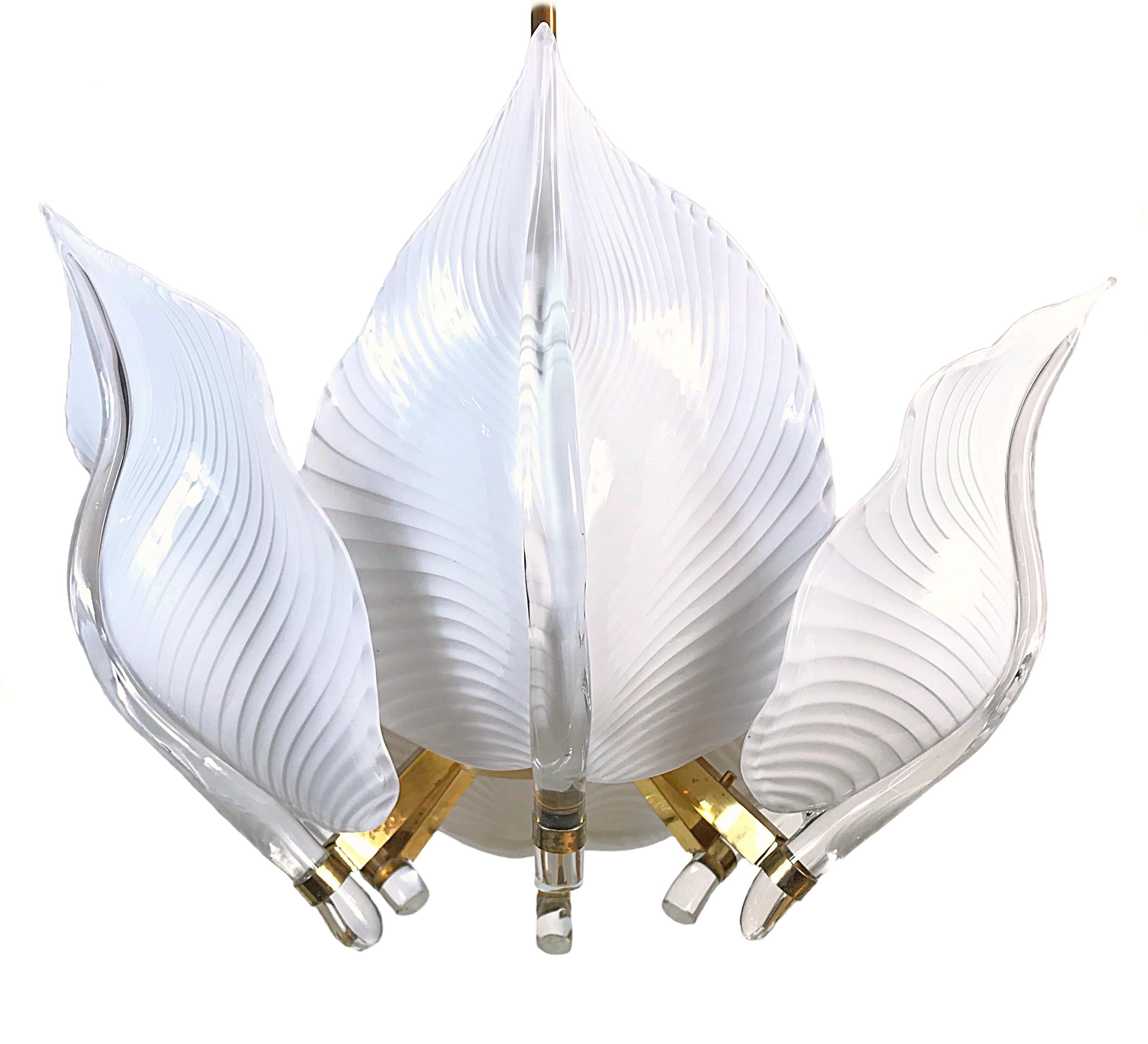 Beautiful hand blown Hollywood Regency chandelier made by Franco Luce in the 1970s. It's featuring six huge thick Murano glass leaves and gold plated brass hardware. The lamp is in very good condition with nice patina on brass. Fully working,