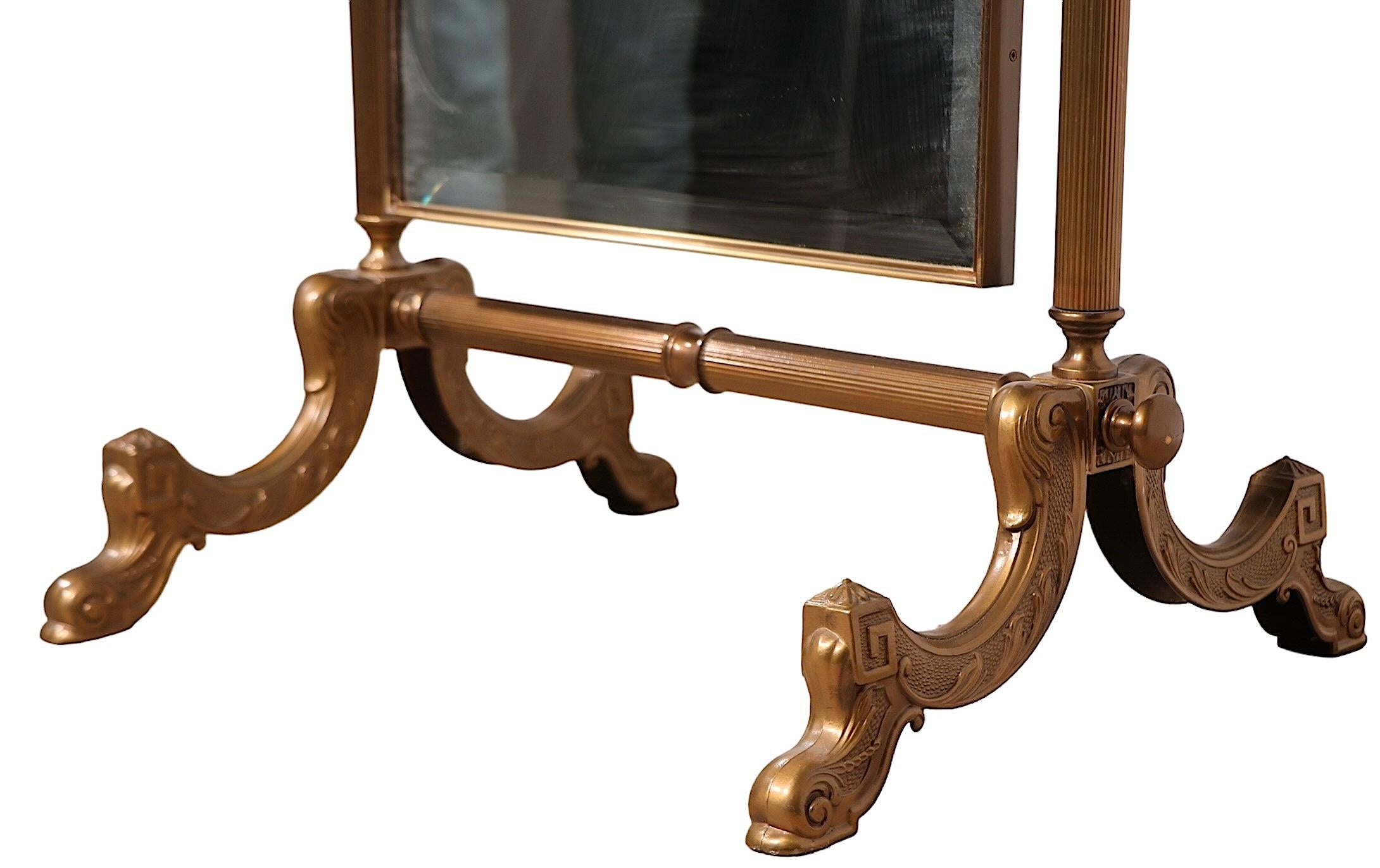 Voguish and chic freestanding cheval mirror in a  cast brass frame, The dome topped bevelled mirror tilts in the supporting frame to adjust to the  exact position you like. Probably made in Italy, or possibly France, in the manner of LaBarge, circa
