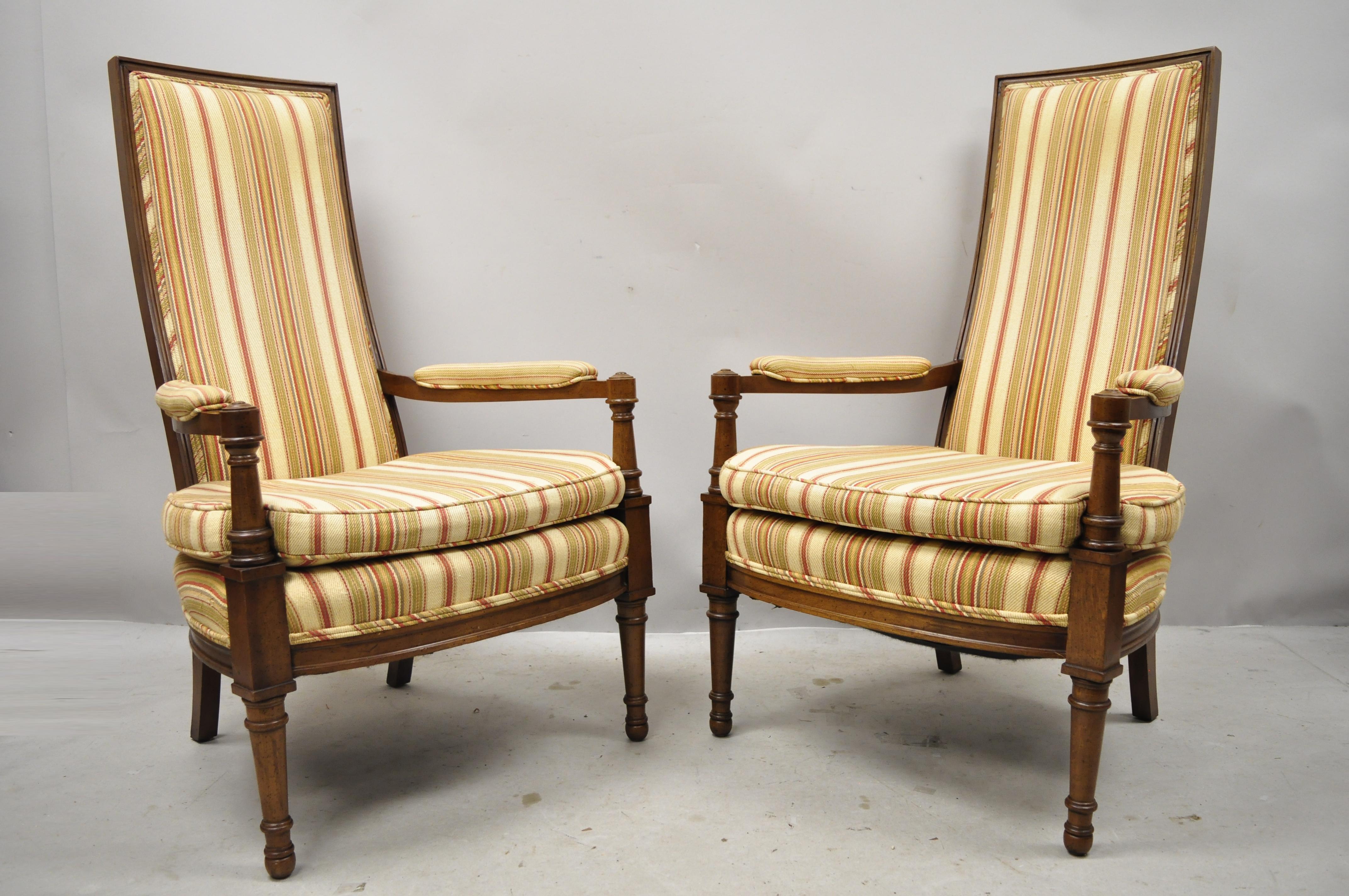 Hollywood Regency French style high back upholstered fireside armchairs - a pair. Pair features tall backs, solid wood frame, upholstered arm rests, nicely carved details, tapered legs, great style and form, circa mid-20th century.
Measurements:
