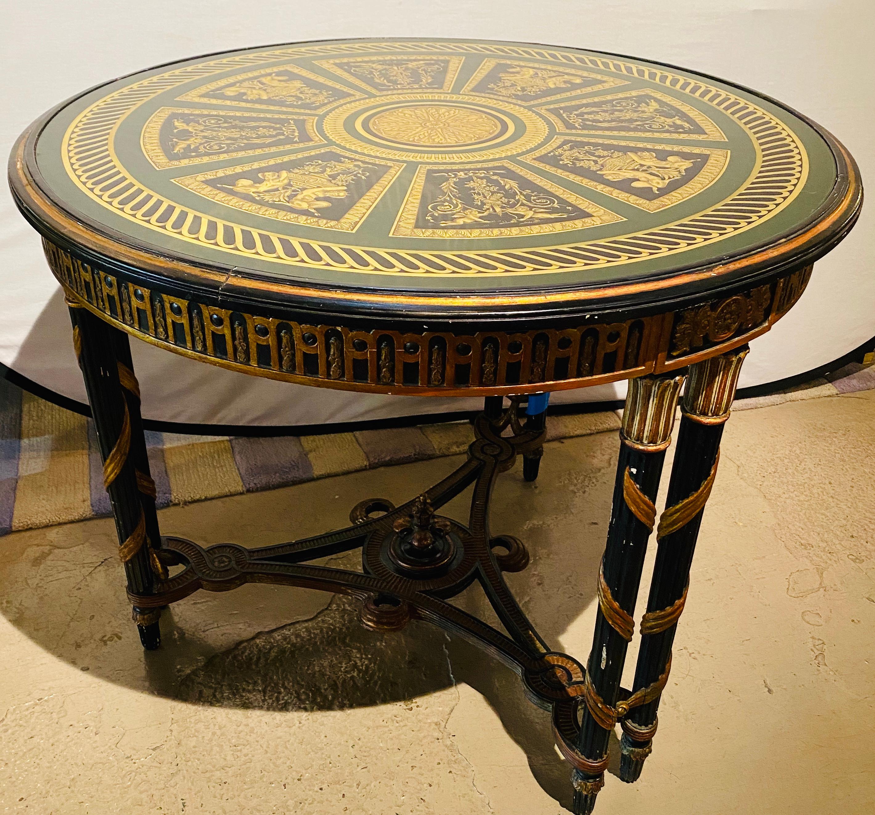 French neoclassical style center table with églomisé glass top of Architectural design. This one of a kind center, end or dining table leaves no stone unturned in the world of decorative design. The ebony and gilt gold decorated églomisé tabletop