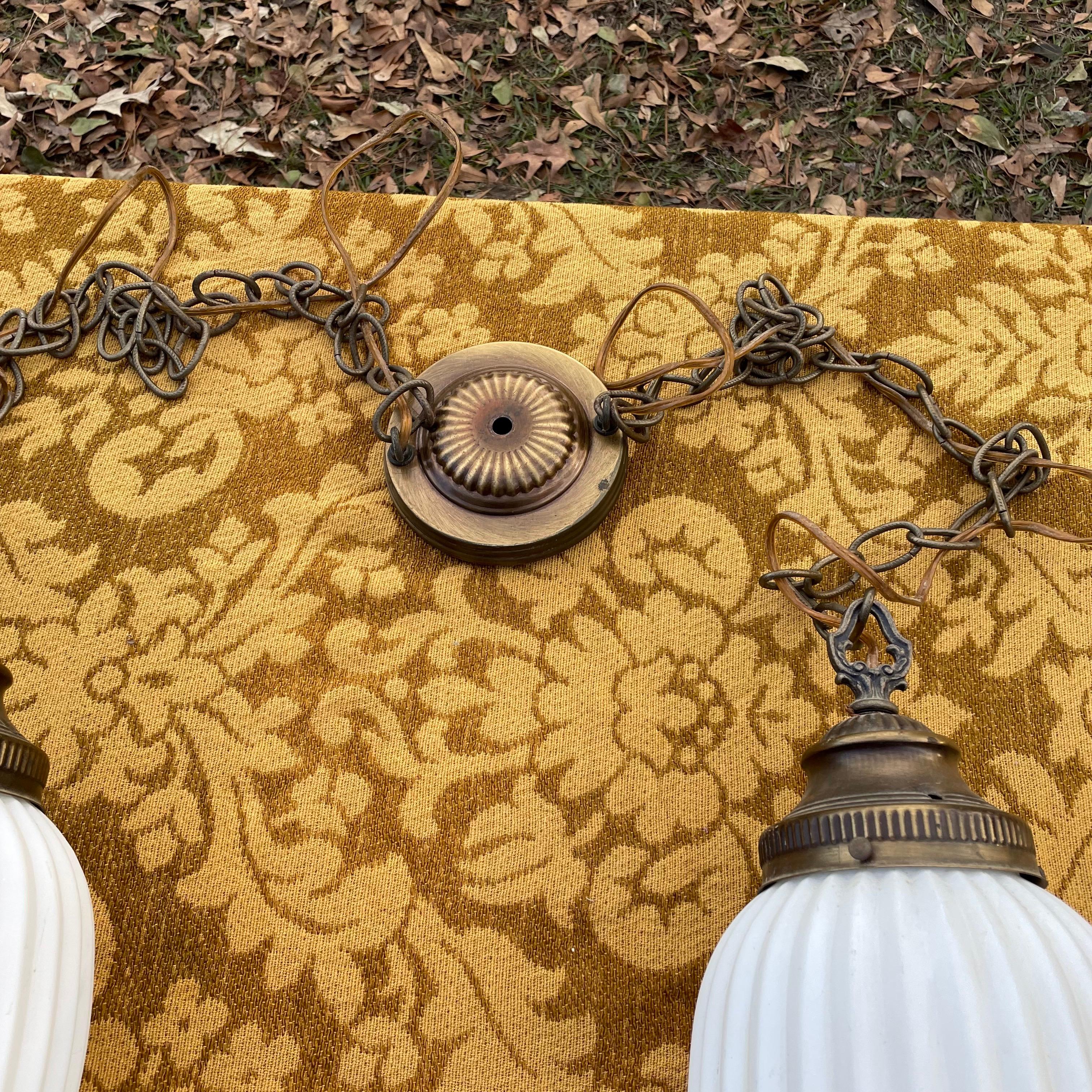 Vintage white frosted milk glass slag lamps in the Hollywood Regency style. The pair of light fixtures are individually wired so you could separate them. Takes a regular light bulb. The chain measures 35 inches in length. 

No chips or cracks in