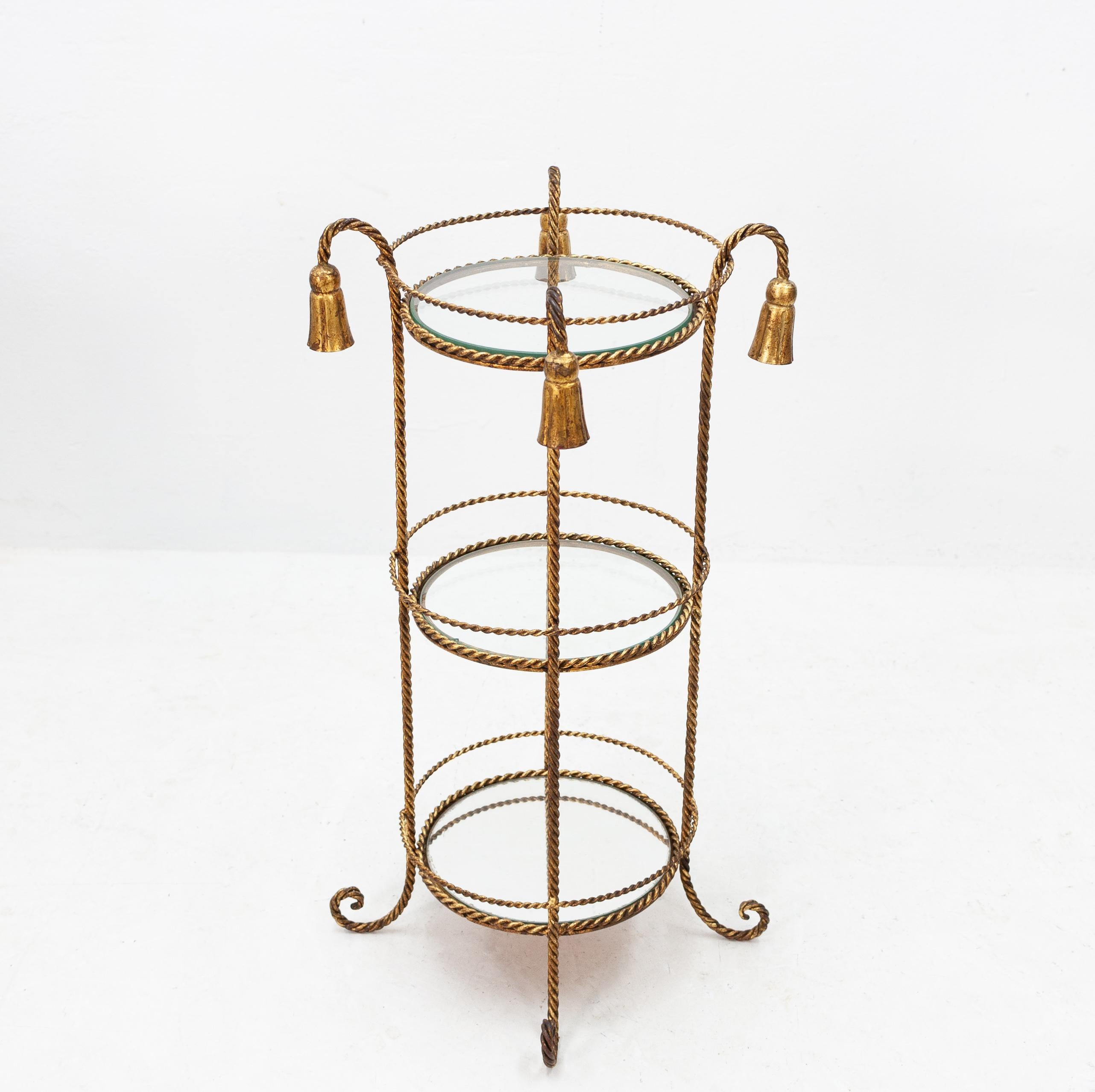 Italian gild metal occasional table. Lovely small table. Comes with still there original gilding
A warm antique gold color. With two glass tops .and a mirror at the last top.
