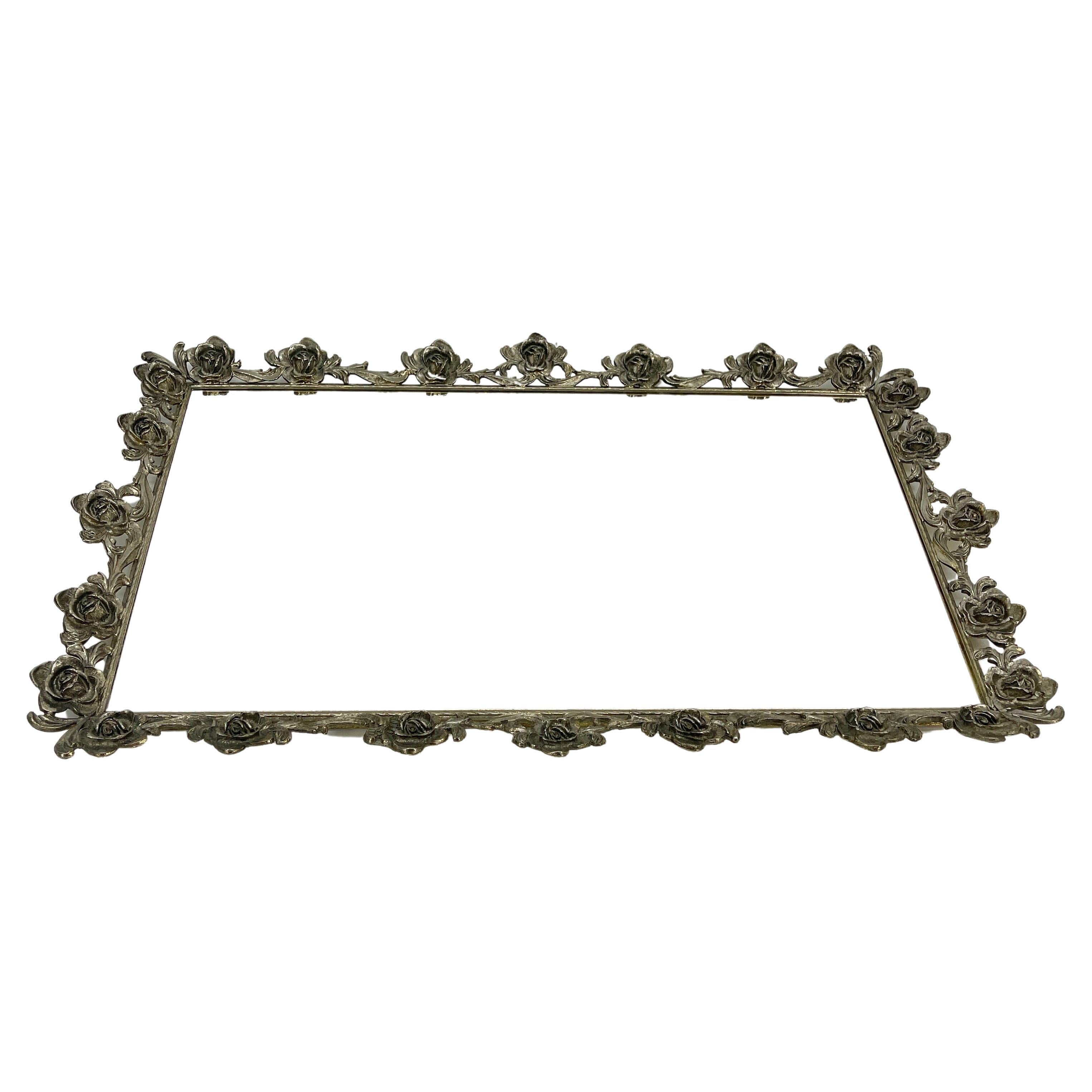 Hollywood Regency gilded vanity tray. Large rectangular hand forged ornate tray with ornate rose floral design. The delicate floral design is beautifully elegant. The tray is sturdy and is as comfortable resting on top of a dresser, dining table or