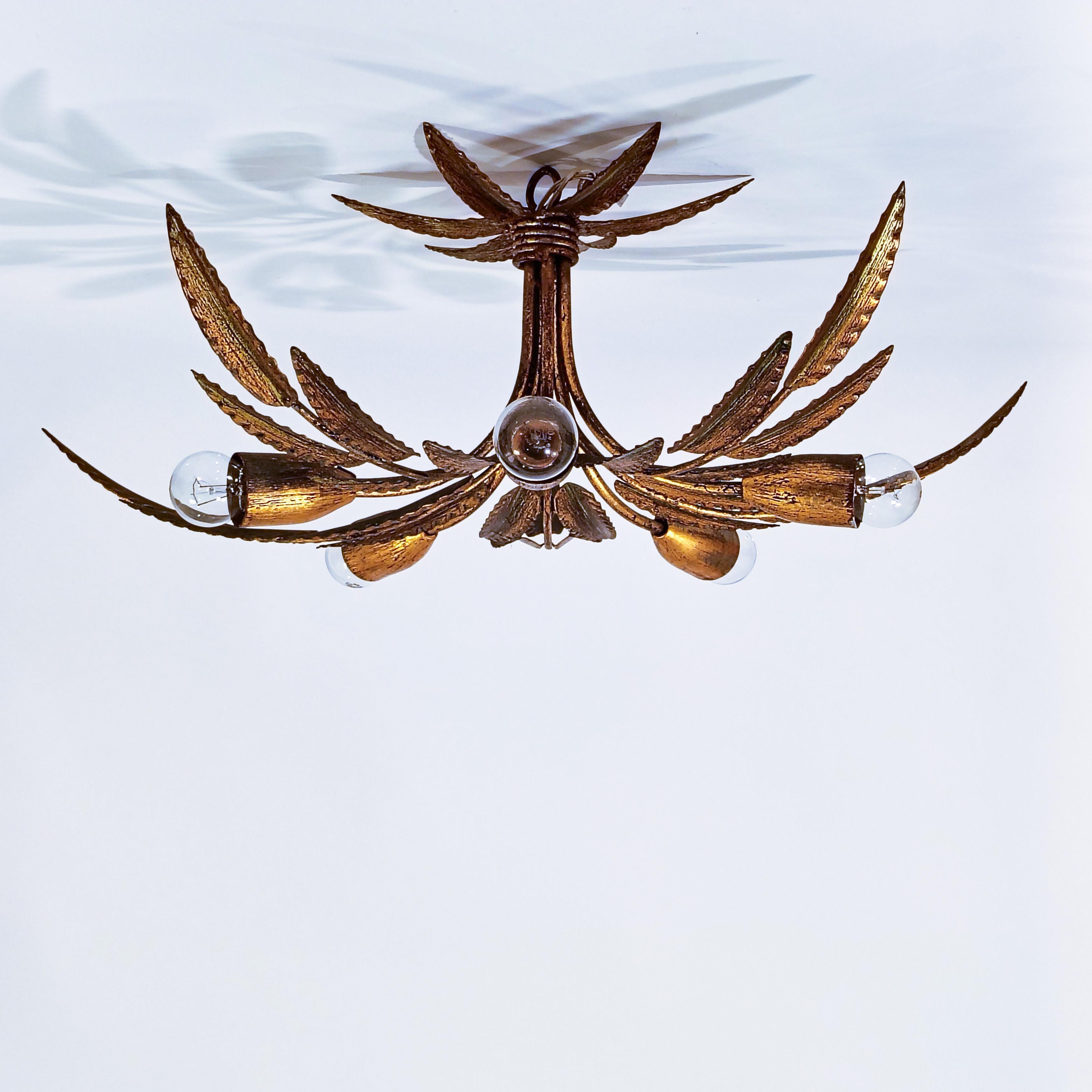Hollywood Regency. Gilded leaves flush mount by Ferro Art, Spain, 1950s. Metal structure composed of several plant branches welded together in the form of a bouquet that emerge from the center, among which are arranged 5 lamp holders. Manual