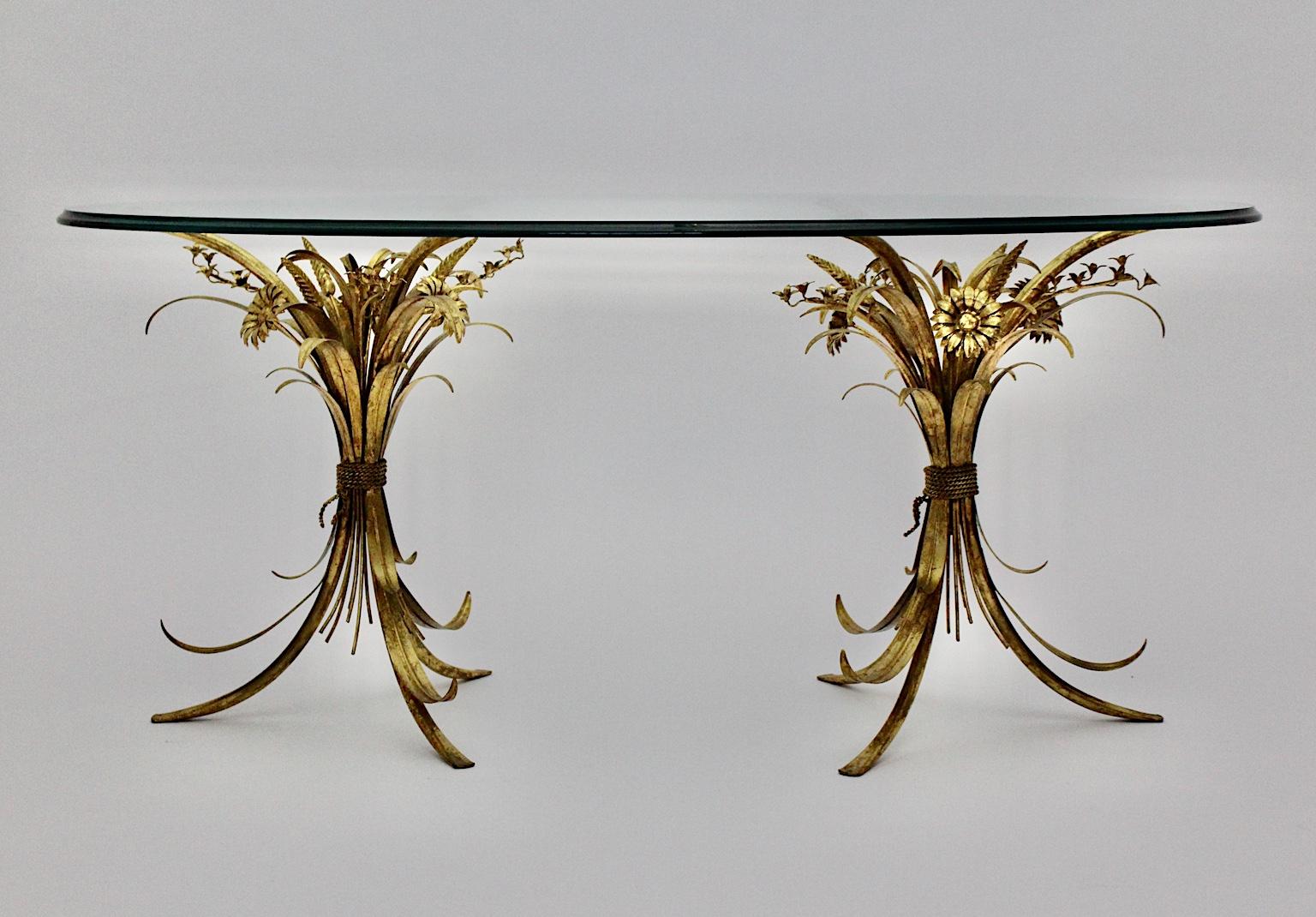This gorgeous Hollywood Regency gilded oval coffee table shows two flower bouquets as a base. Furthermore the vintage coffee table features an oval shaped glass plate and two bases.
The vintage condition is very good with minor signs of age and use