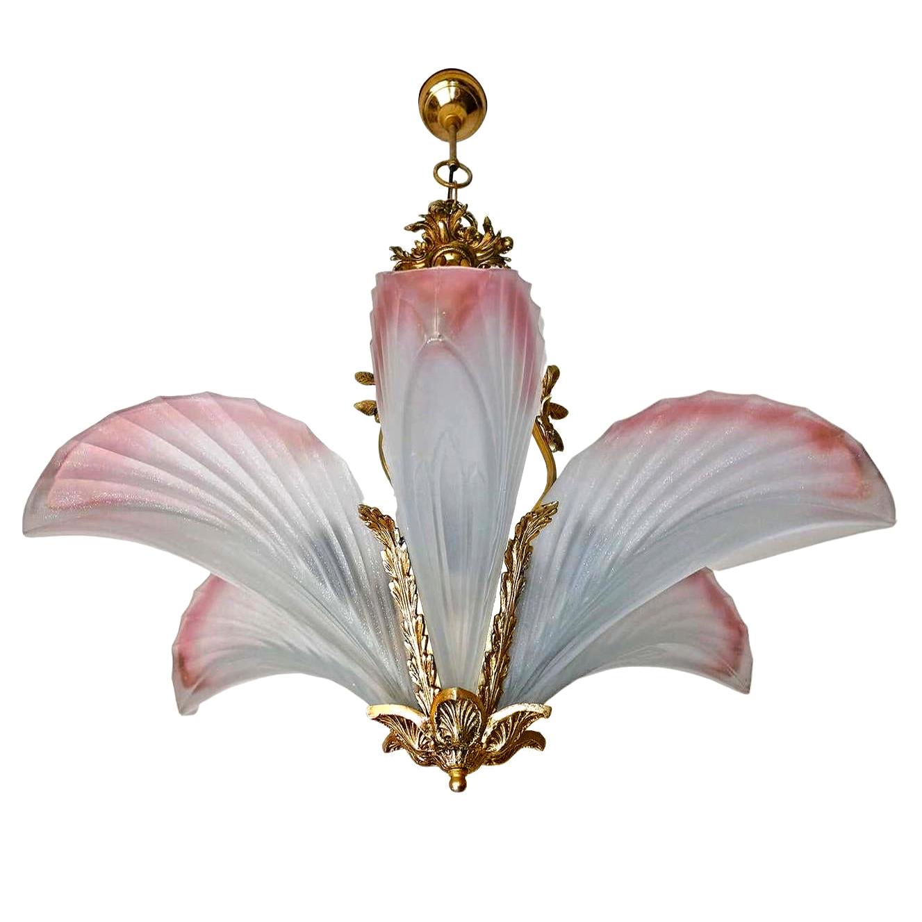 This stunning high quality fixture is from the mid century and created in a Classic Art Deco form. It features solid bronze frames, unusual pink thick frosted glass shades, and take 6 standard bulbs. It also includes it's original brass hanging