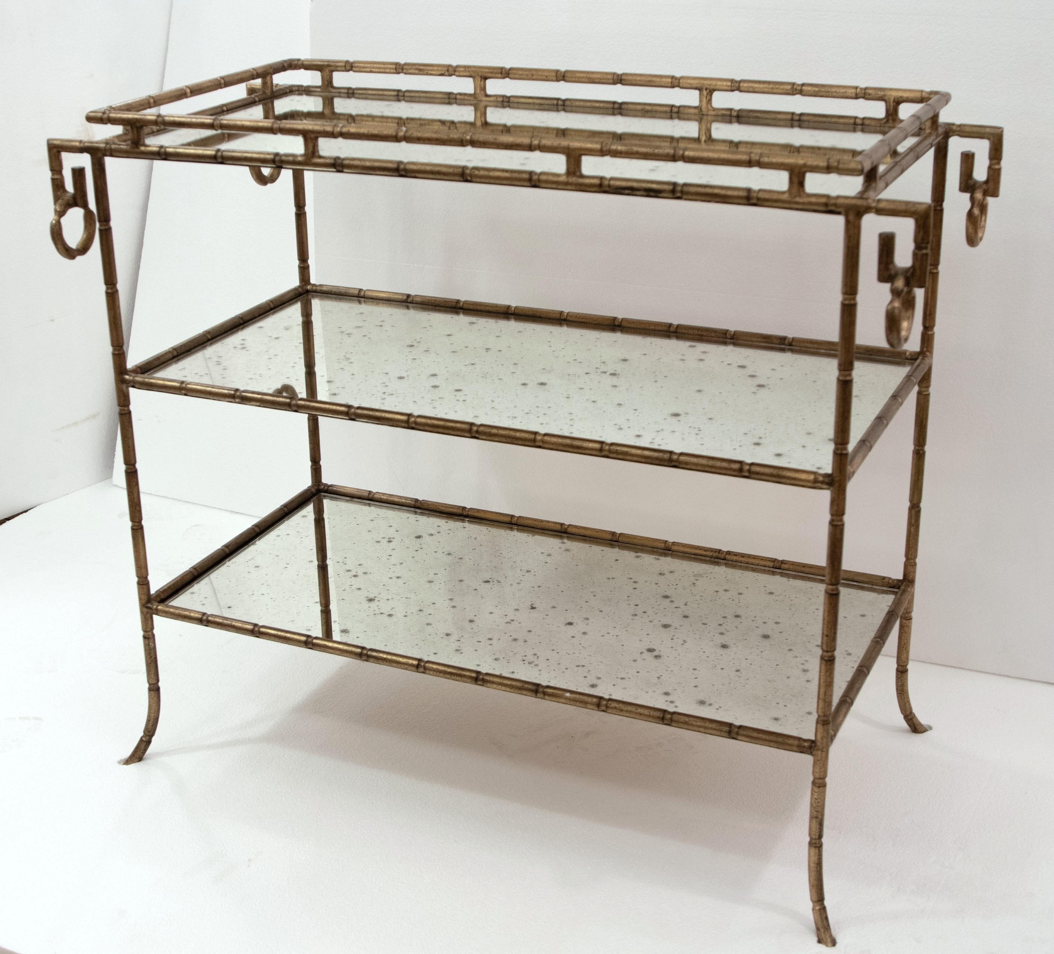 Hollywood Regency bar table with two glass shelves in a gilt iron construction. Good condition with appropriate wear from age. One available. Please note, this item is located in one of our NYC locations.