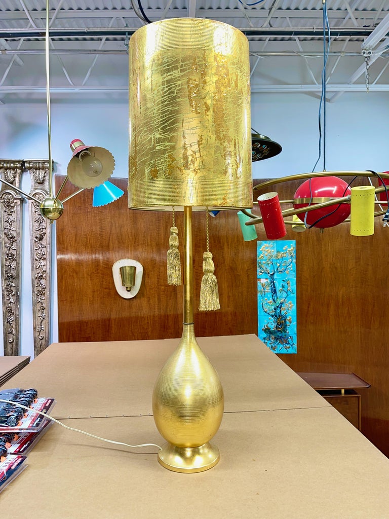 From an outrageously over the top Hollywood Regency decorated home, large scale custom lamp from Boston's Allen Furniture circa 1962. Bulbous metal bottle form vase turned with incised horizontal grooves mounted on a round tapered metal base and