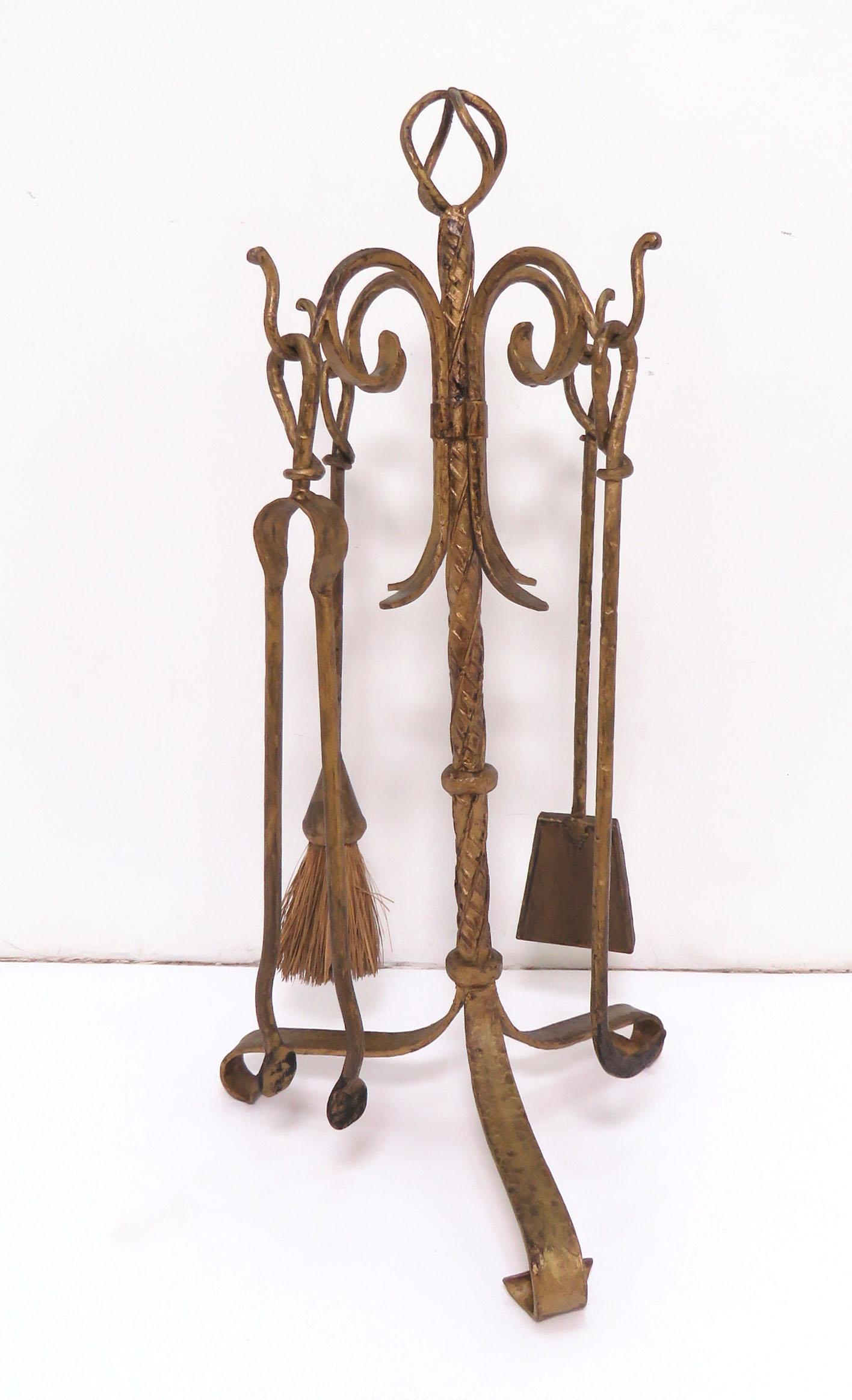 A set of four fireplace tools with stand in gilt metal. Unmarked, almost certainly Italian.