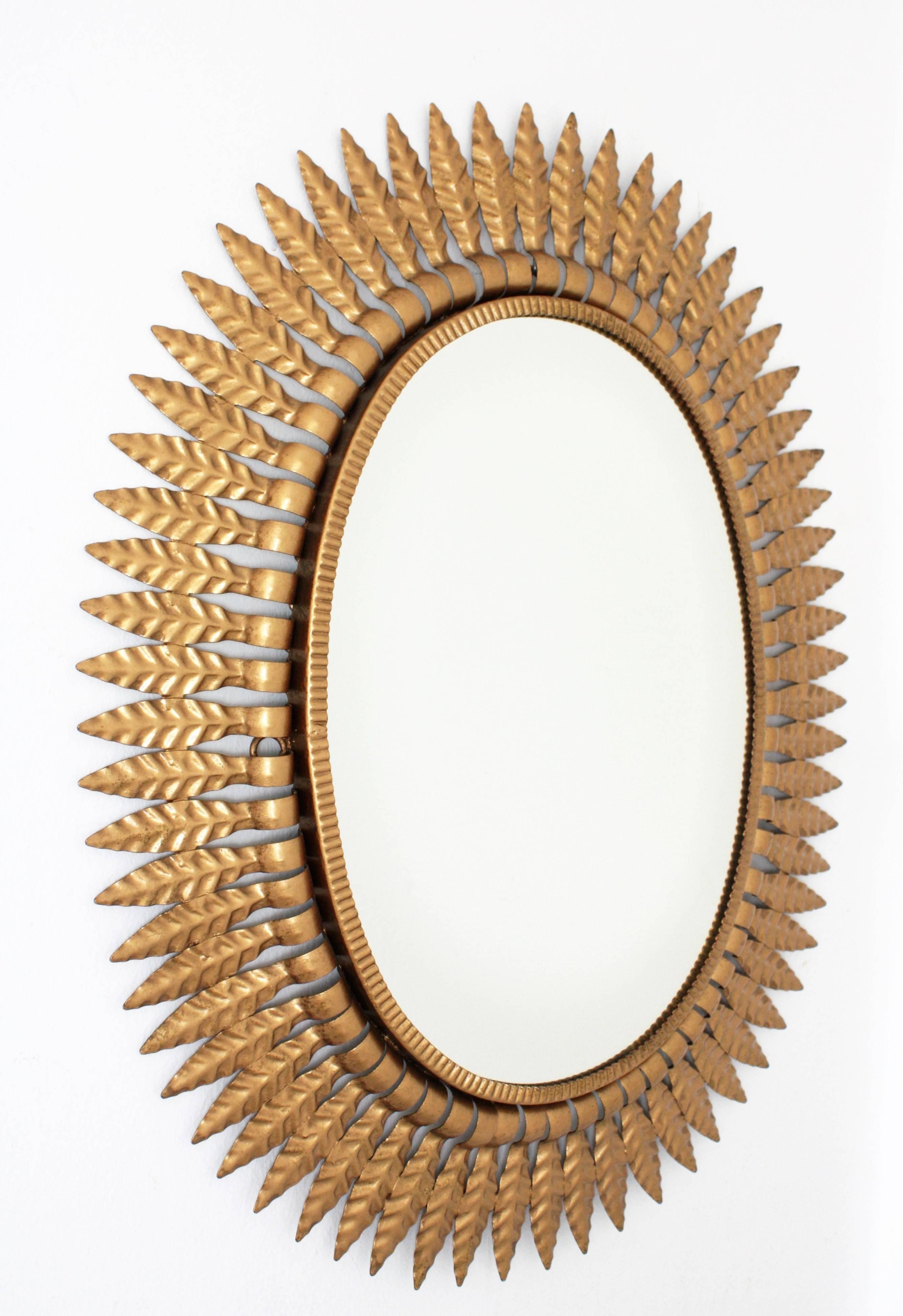 Mid-Century Modern Hollywood Regency Gilt Metal Oval Sunburst Mirror, Spain, 1950s