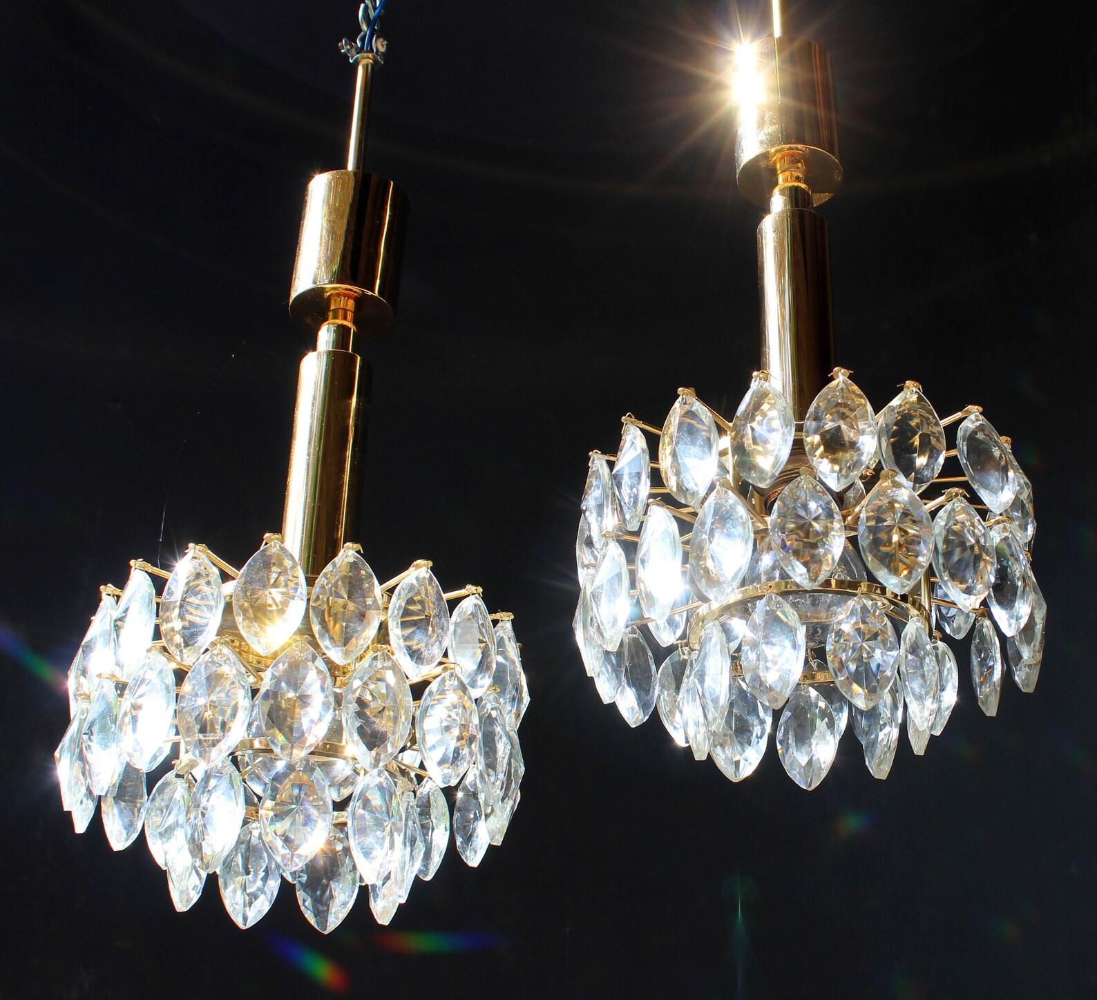 Pair of elegant 1 light (e27) gilt brass & fine lead crystal chandeliers 1970´s / Schröder Leuchten / Germany

Each 1 light & 45 grand crystal drops

Measures: Diameter 9 inches height of the body 6 inches original height 24 inches

These fine