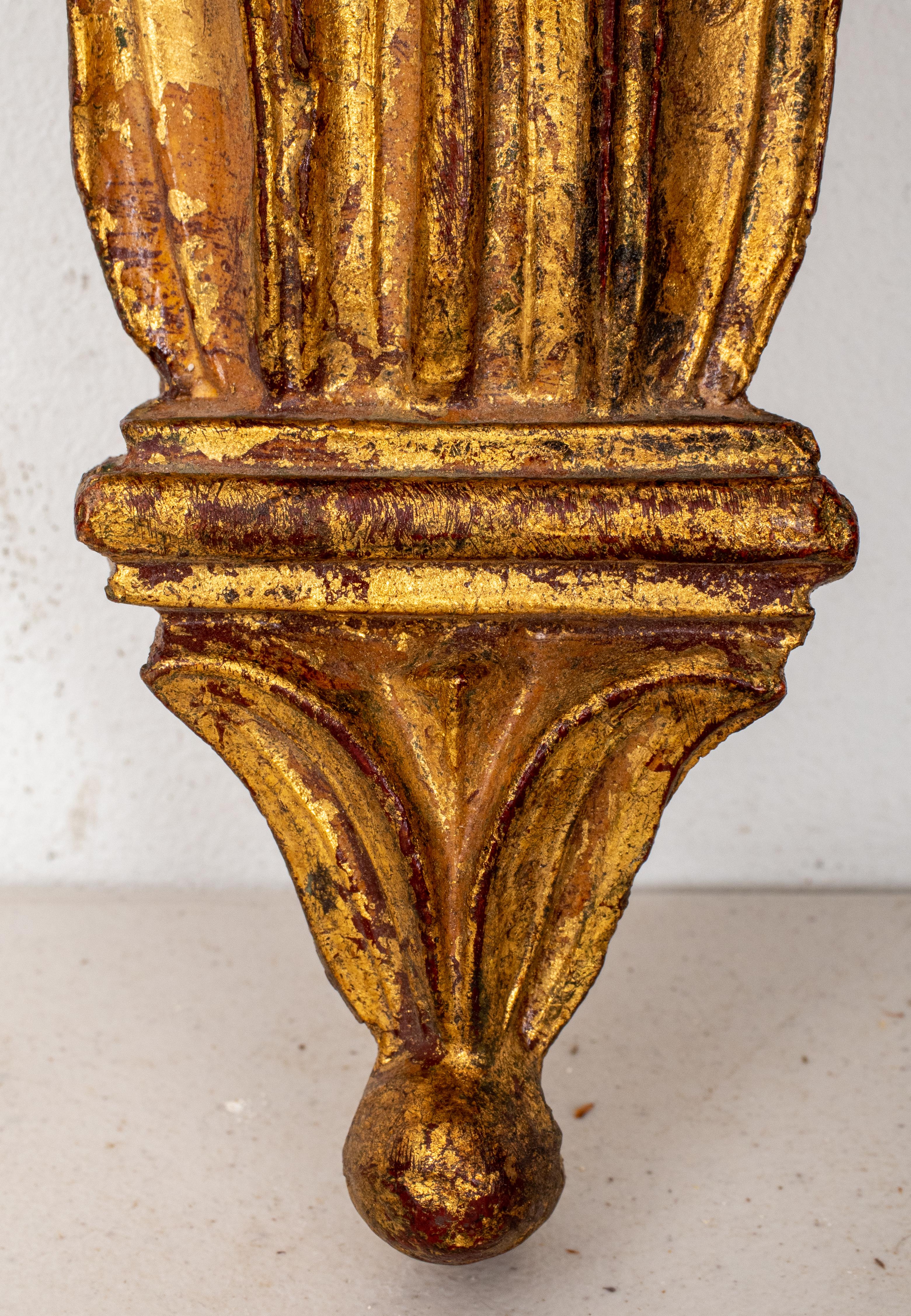 Hollywood Regency giltwood bracket, with molded shaped bracket above a modified scrolling Corinthian capital terminating in a pendant finial. 
Measures: 10.5