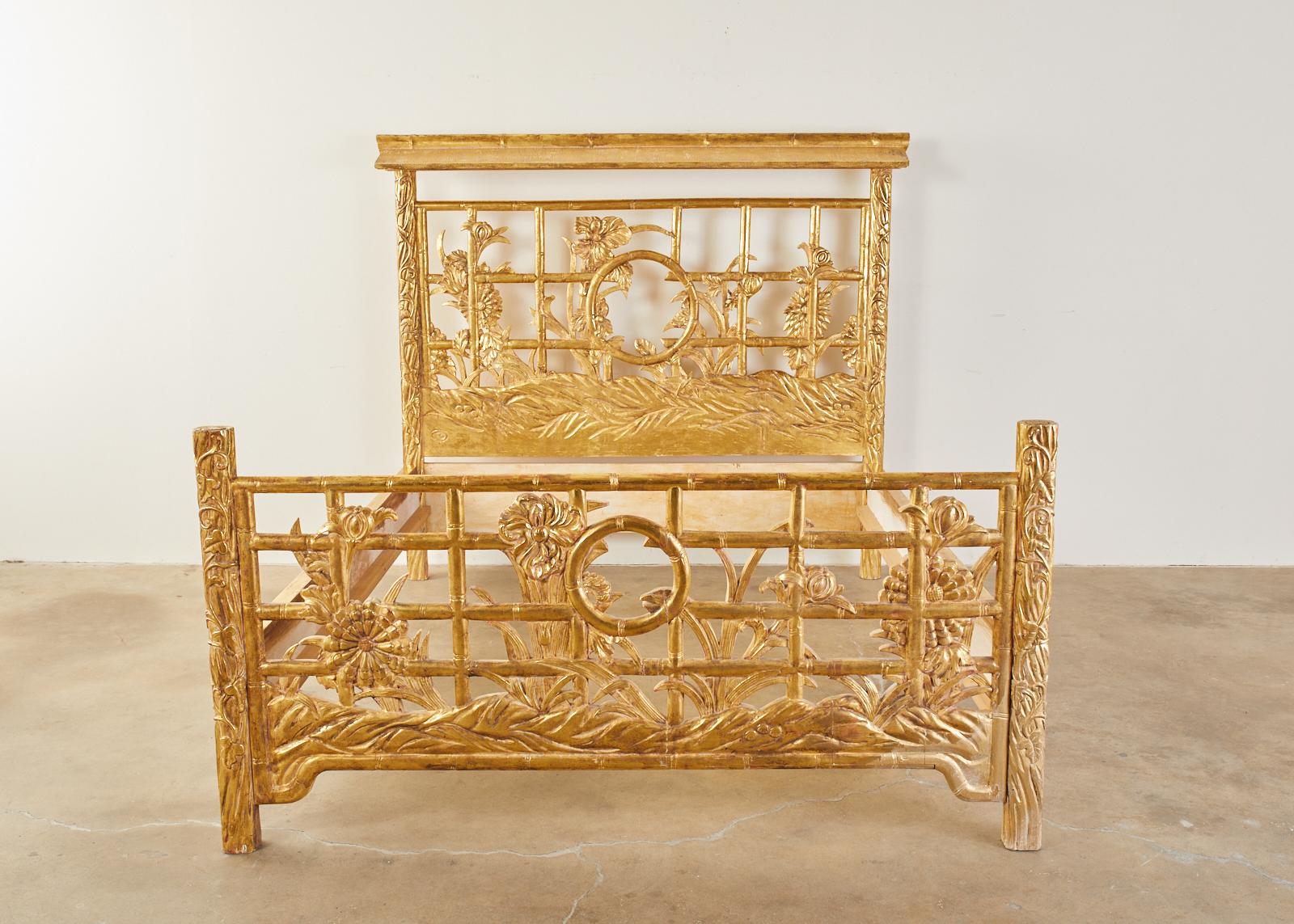 Fantastic midcentury faux bamboo giltwood bed from the Hollywood Regency period. Features an open fretwork design of faux bamboo on the head and baseboard with floral and foliate growing through the lattice. The headboard has a pagoda roof fragment