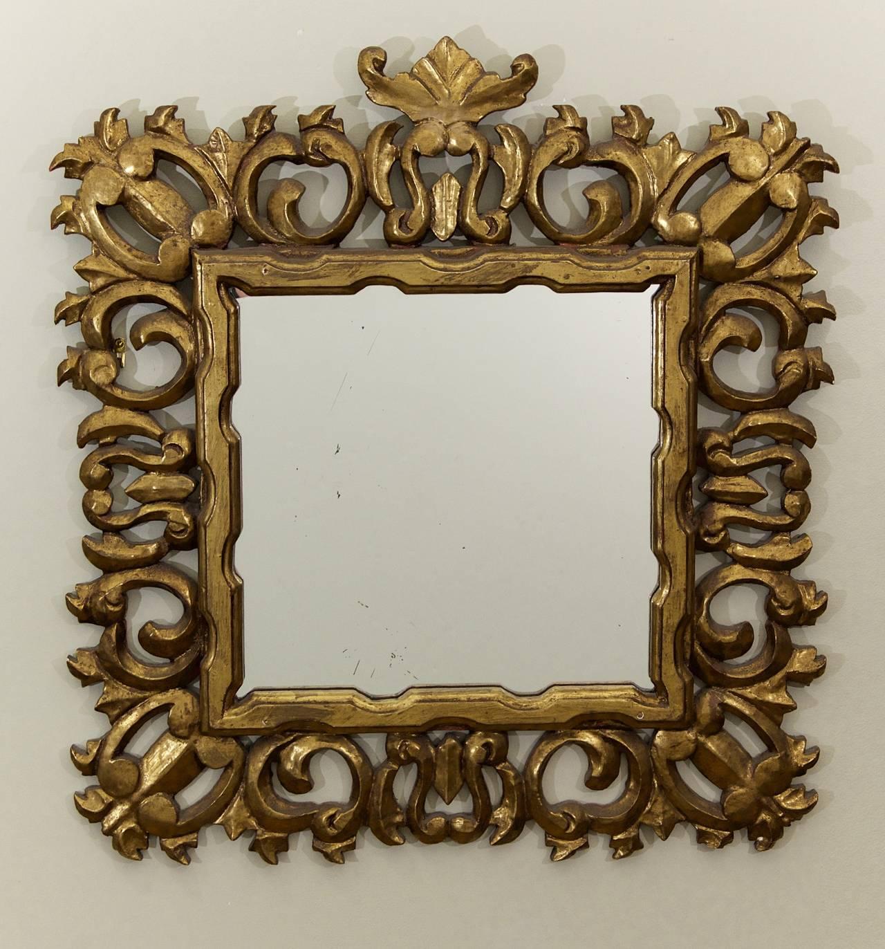 Excellent Hollywood Regency mirror, the overscale carved frame in gessoed giltwood. Dramatic and well-formed.