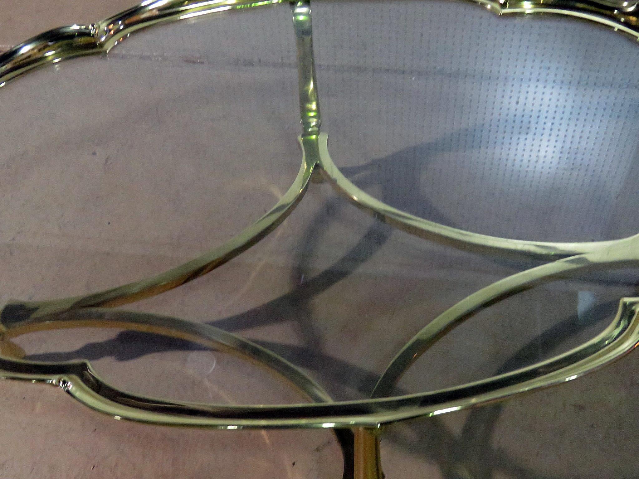 This is a glamorous Hollywood Regency brass and glass top coffee table with a scalloped top, attributed to Labarge. LaBarge made some of the heaviest and most beautiful coffee tables with inspiration of the French and English and creating