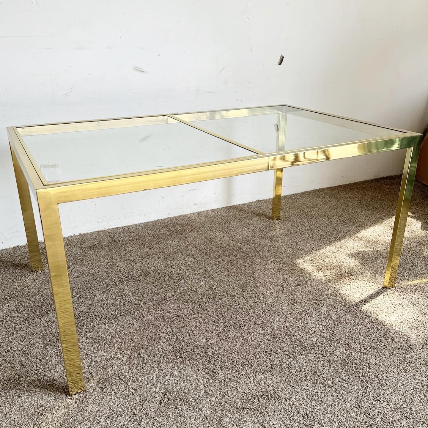 The Hollywood Regency Gold and Glass Dining Table by DIA is a statement of elegance and luxury. With its opulent gold frame and sleek glass top, this table embodies the glamorous Hollywood Regency style. Ideal for those seeking a blend of classic