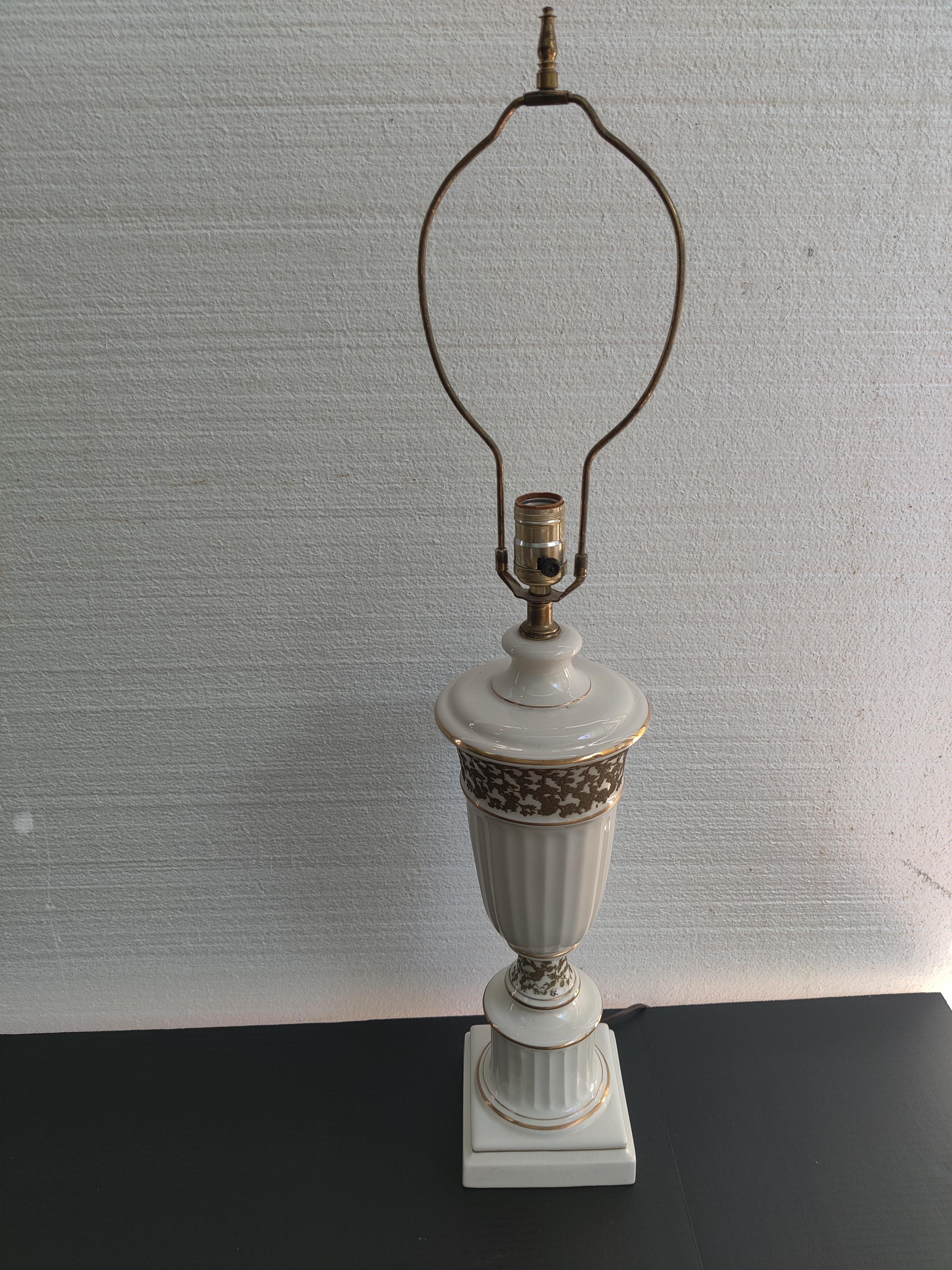 Hollywood Regency Gold Gilt Embossed Trim Ceramic Lamp with finial.
Lamp works.  
Base is 5