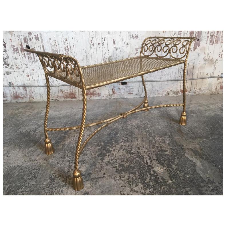 Vintage wrought iron vanity bench circa 1950s features twisted rope and tassel detailing. Very good condition. Professional reupholstery available.