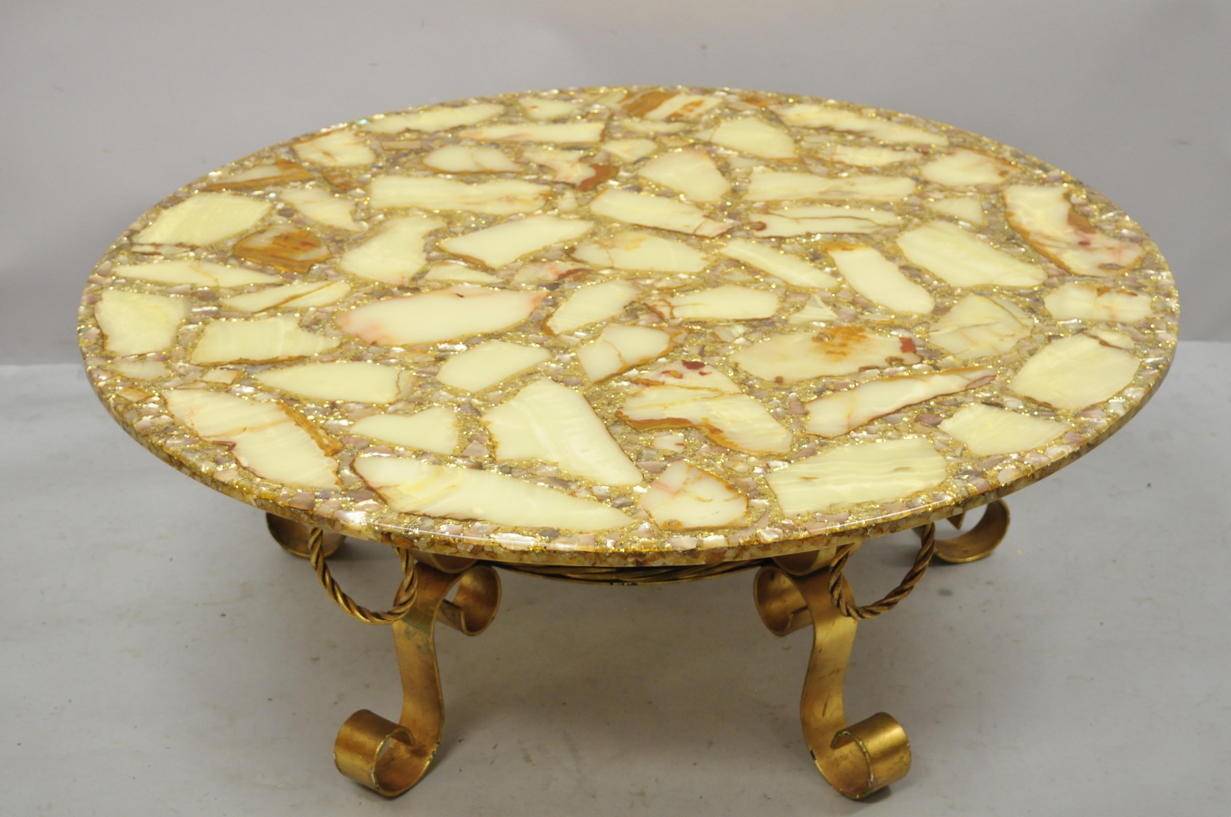Vintage Spanish Hollywood Regency gold iron scrolling base round agate stone specimen resin top coffee table. Item features wrought iron gold finish scroll work base, round resin, stone, and agate specimen top, great quality, wonderful style and