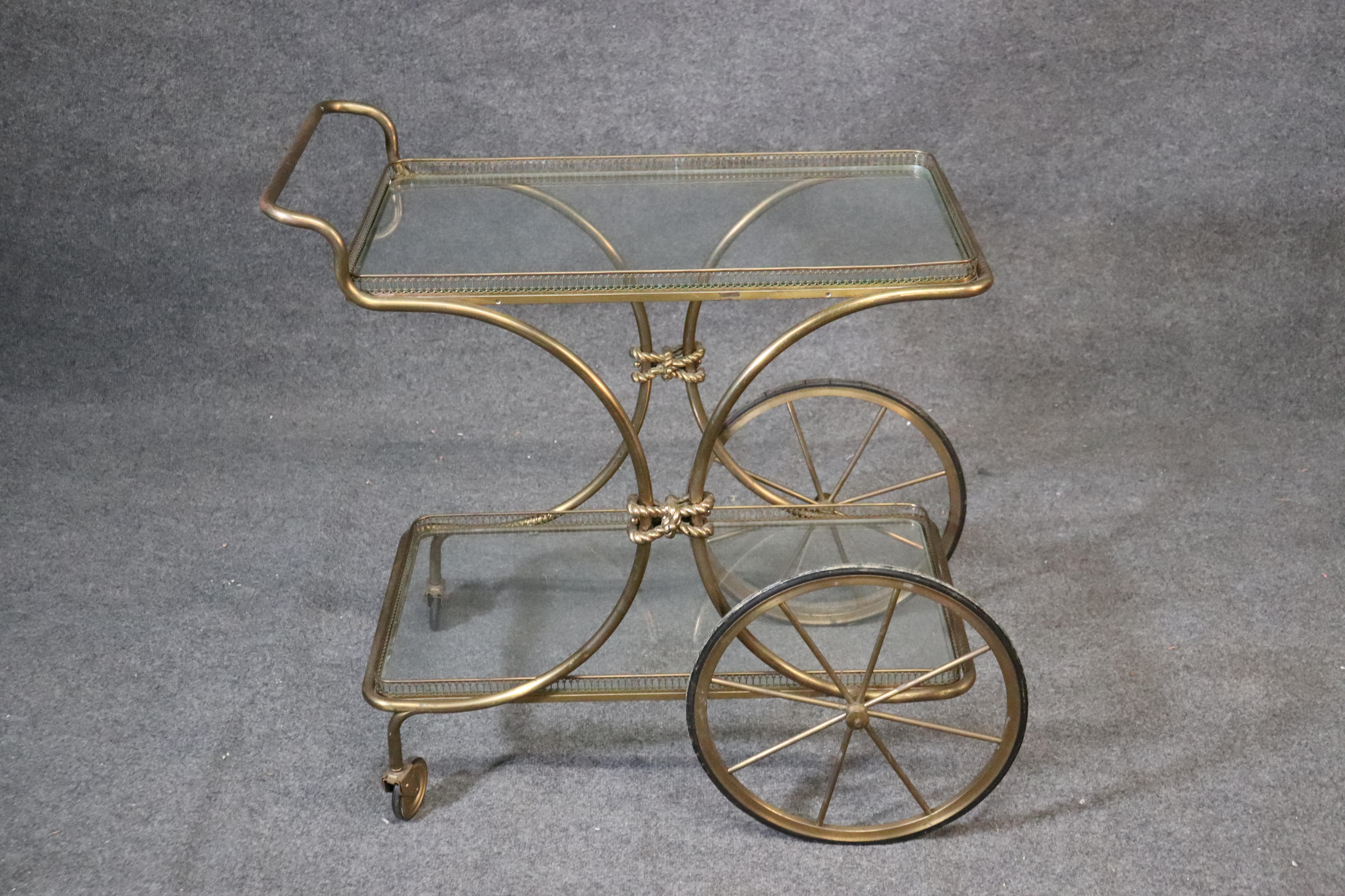 This is a fantastic tea trolley in genuine gold leaf. The trolley can be used as a liquor cart or dessert cart or simply as a tea trolley. The cart measures 31 tall x 31 wide x 20 deep. The cart dates to the 1950s era and is Italian.
