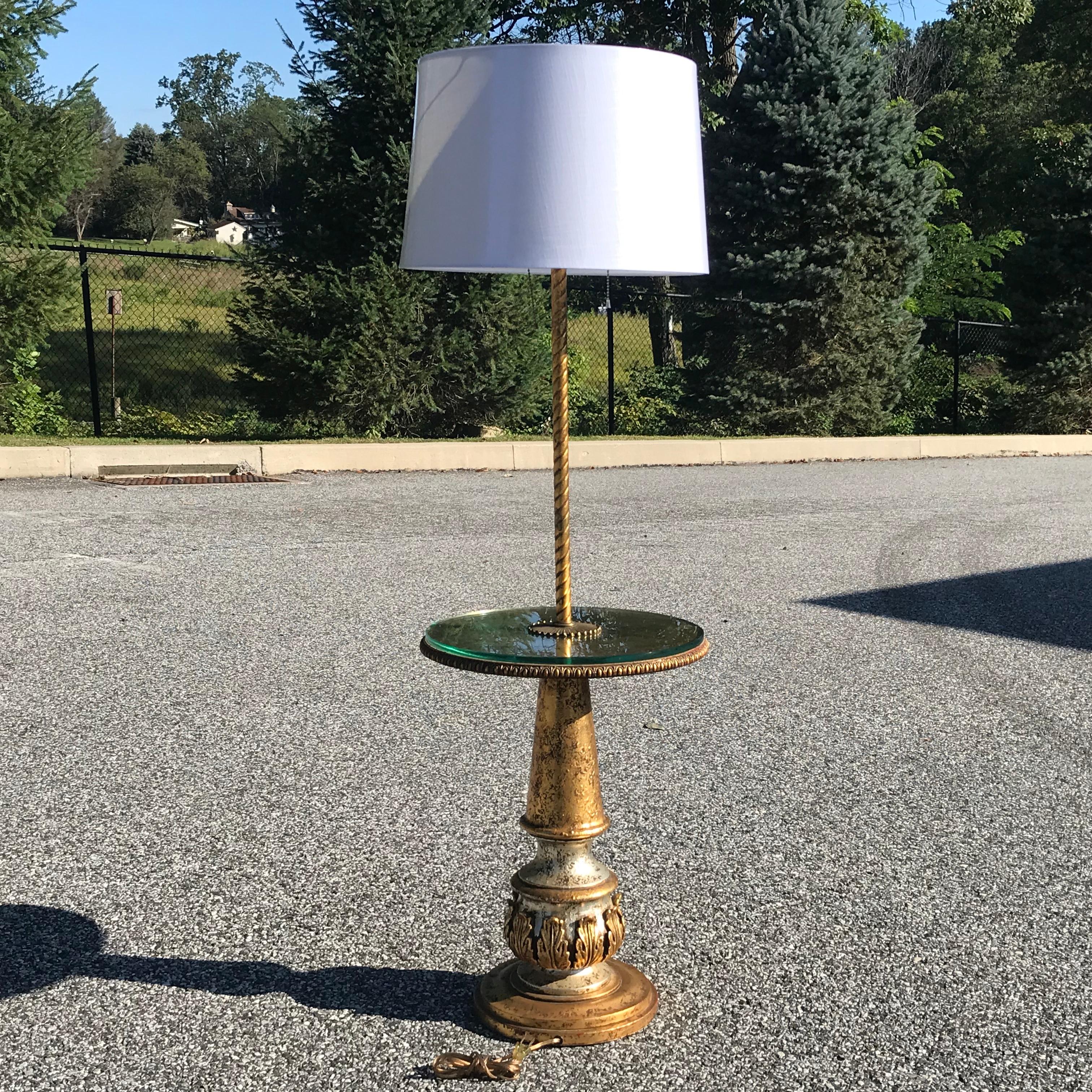 Vintage Hollywood Regency floor lamp by Nardini Studios of Los Angeles CA with double lamp socket and a gold leaf glass table over sculptural base. Shown with new standard XL shade which is included. Table height 22.25