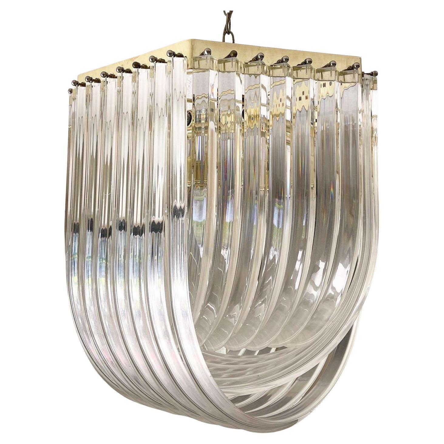 Hollywood Regency Gold Lucite Ribbon Loop Carlo Nason Style Lucite Chandelier For Sale