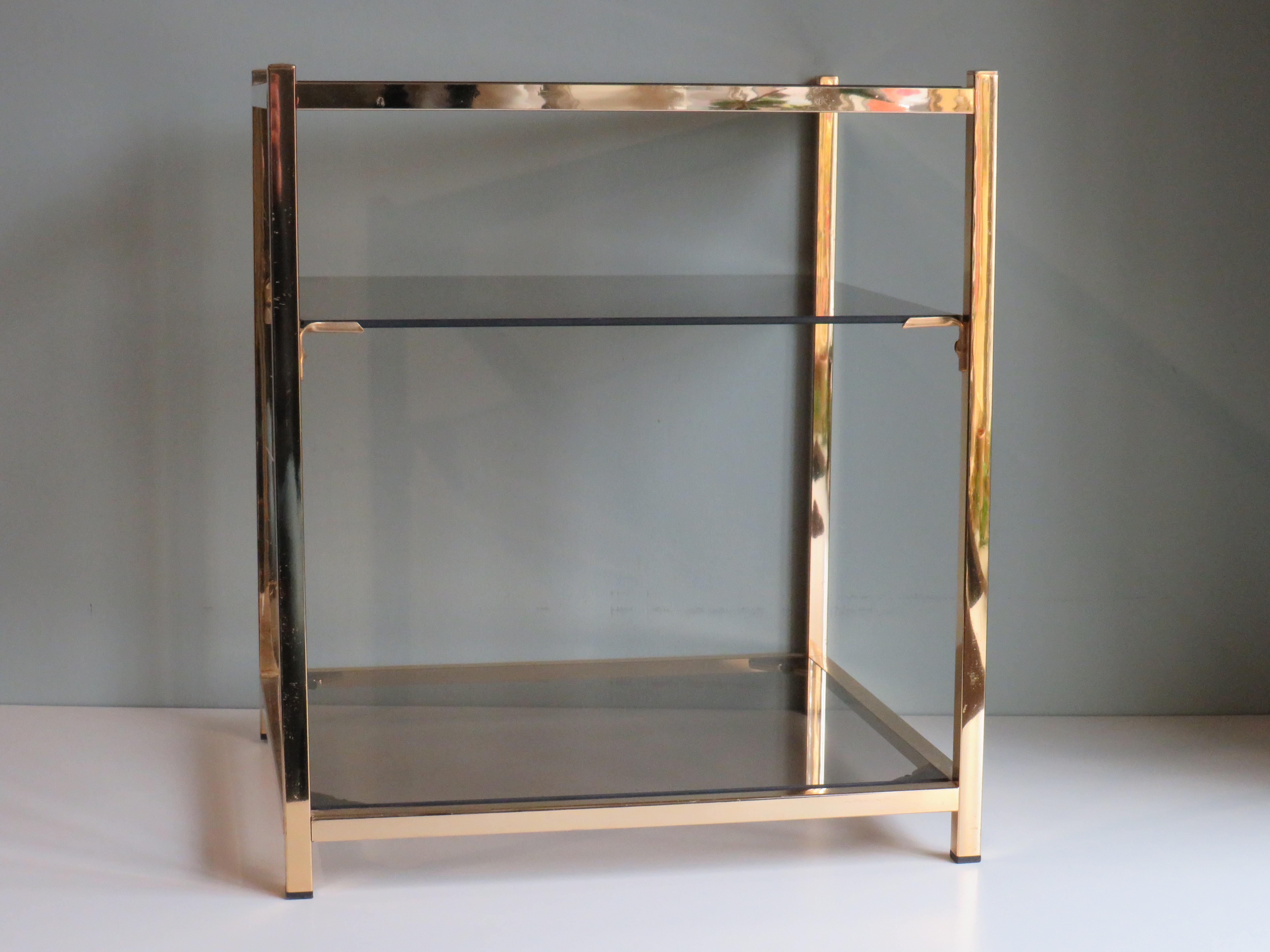 Side table in gold-plated metal and 3 smoked glass tops.
The table has a height of 50 cm, the wide x depth are 39.5 x 43.5 cm.
The table has minor signs of wear, typical of the age of the item, the 3 glass tops are in very good condition.