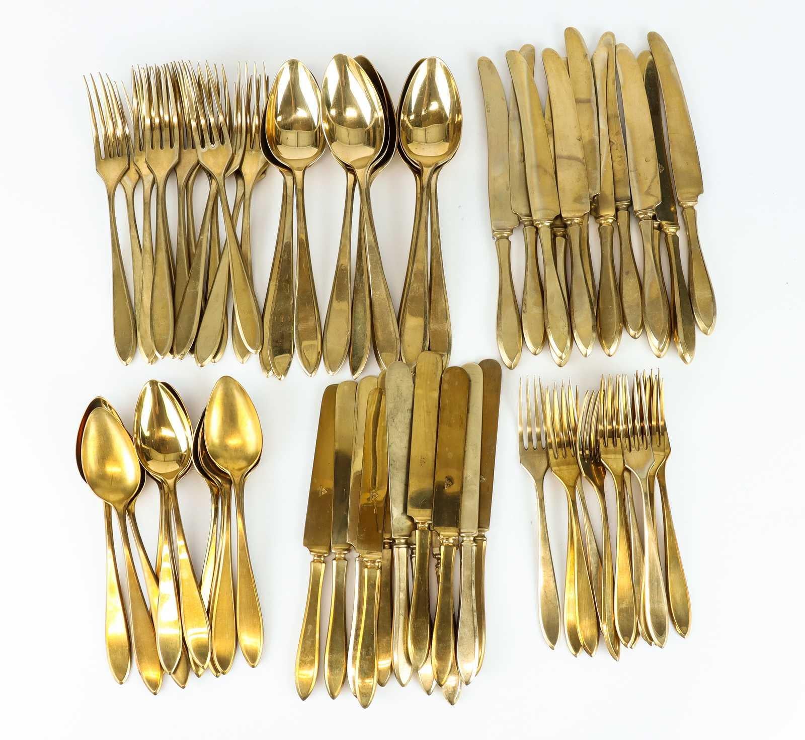 This Hollywood Regency golden hued and rare Dirigold cutlery made during the 1920’s is a solid bronze alloy. 

This set of cutlery is sold together and contains 74 pieces.

Starter cutlery 
12 knives, height: 18 cm
12 forks, height: 18 cm
12 spoons,