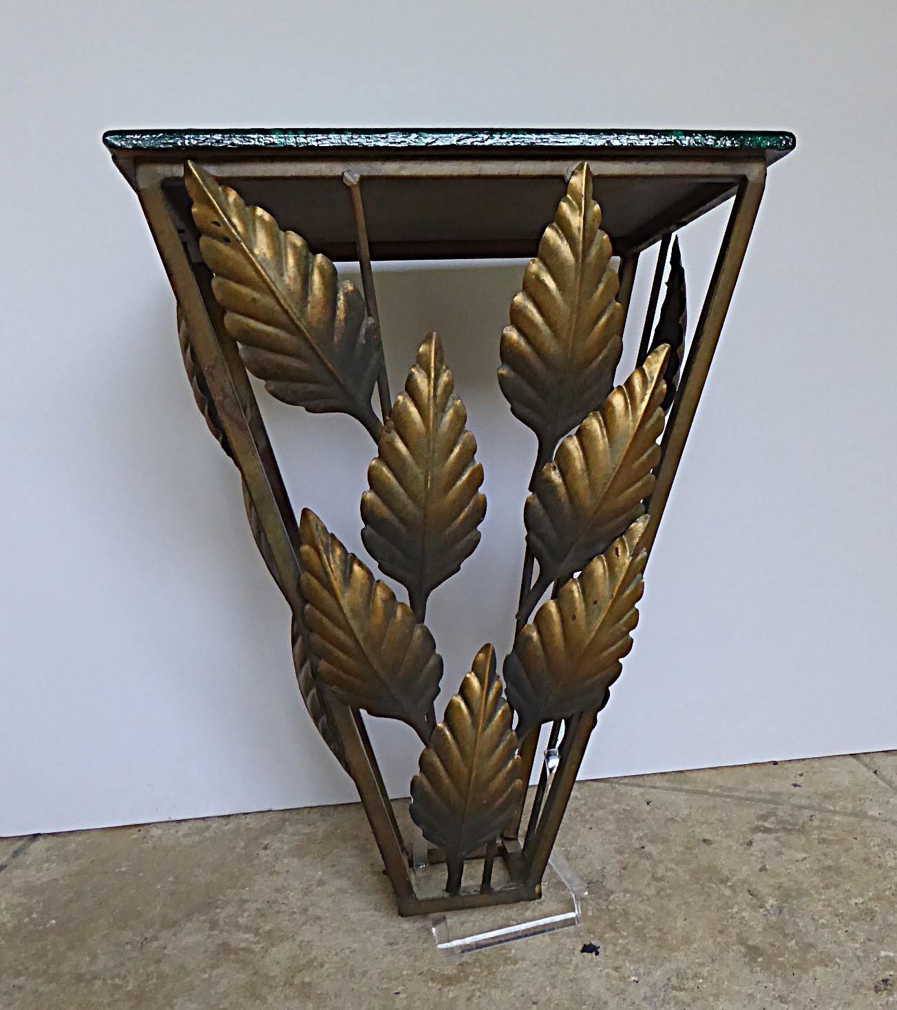 Hollywood Regency Metal Wall Console with golden leaves decor and wooden top painted faux malachite, very nice. Elegant narrow and small footprint console with only a 15″ by 10.5″ painted top and can be hung at the height required.

Condition: The