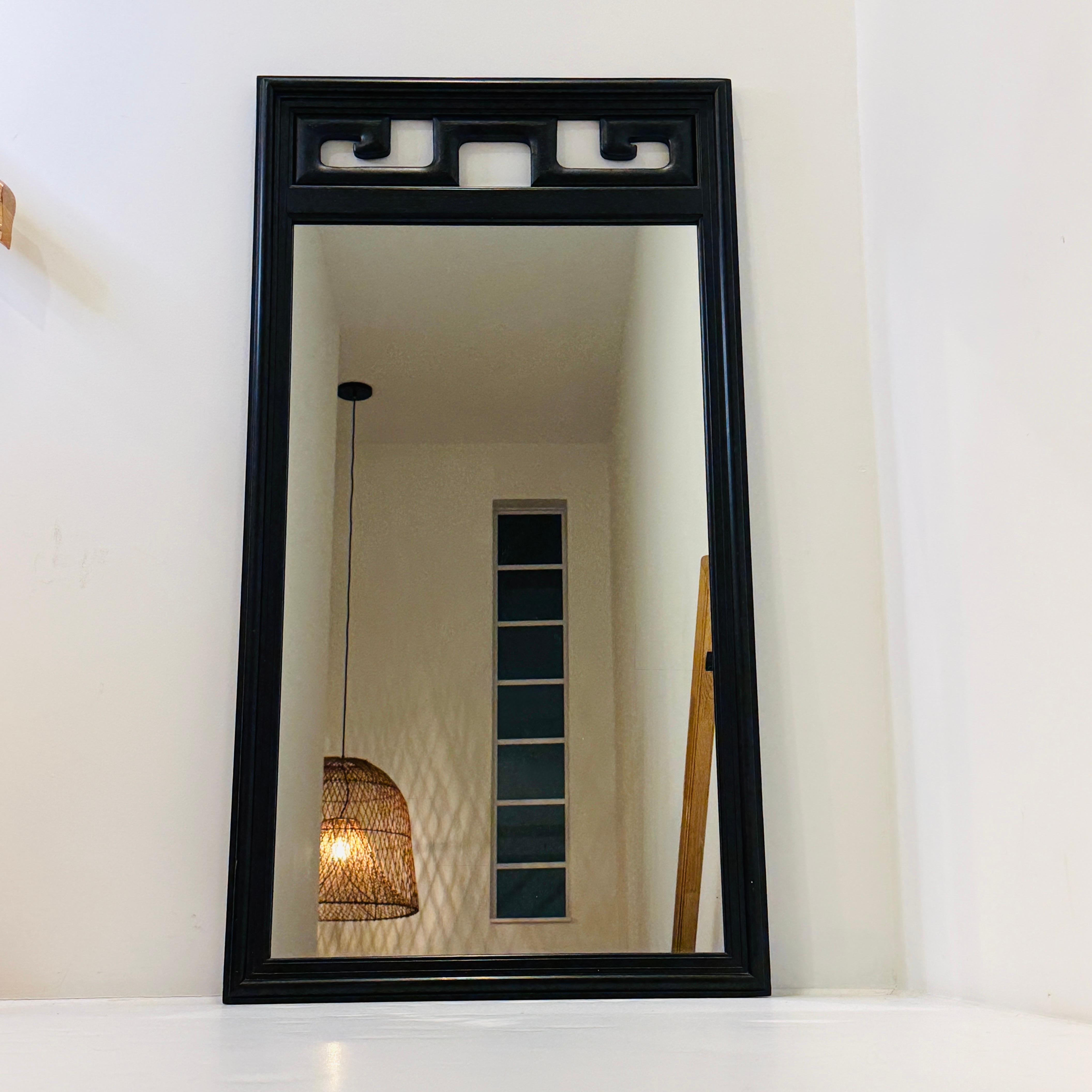 Black lacquered solid wood mirror with carved Greek Key design. The fretwork design is also reminiscent of Asian Pagoda motifs. Elegant design with clean lines and inset frame.